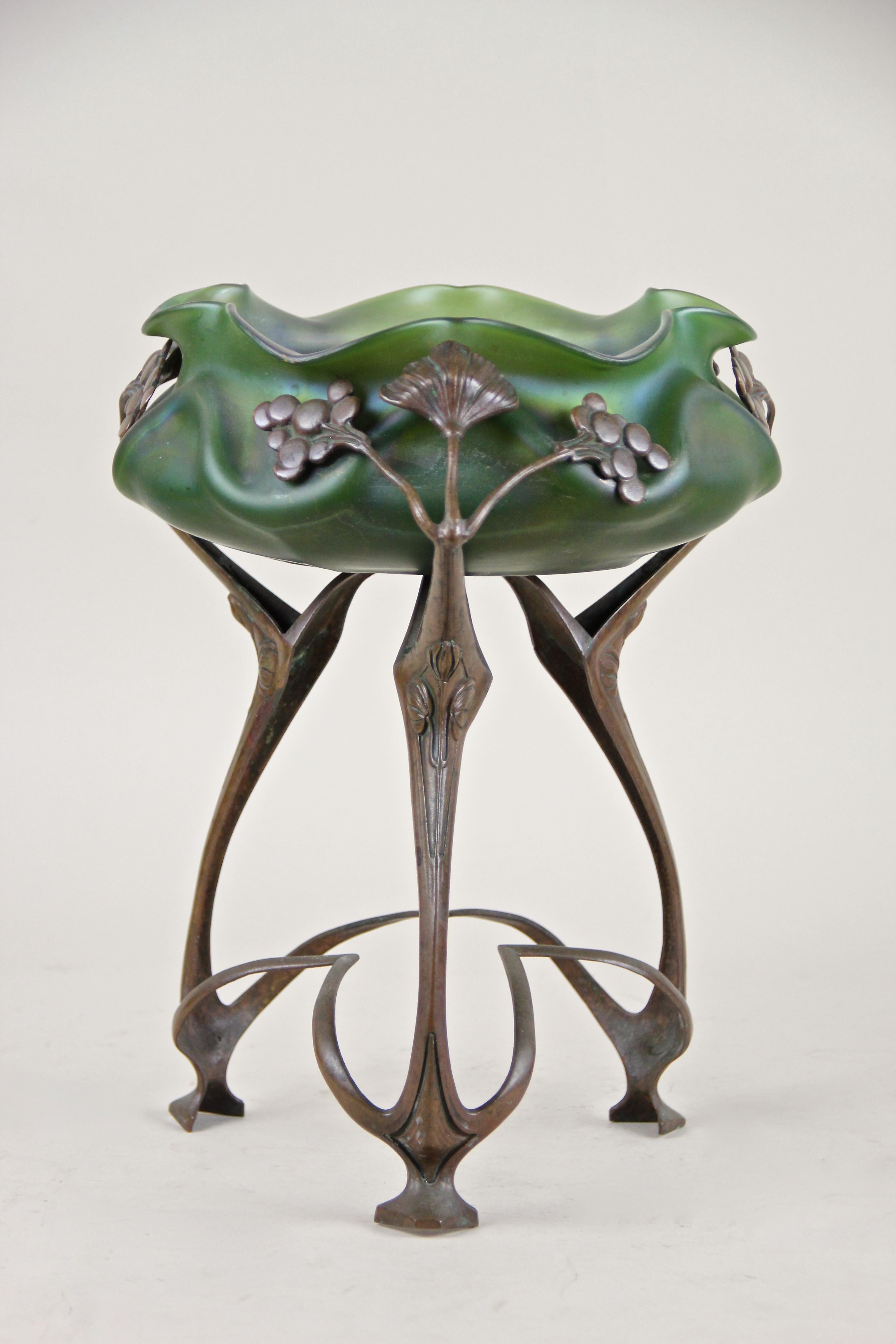 Exceptional bronze centerpiece with iriscident glass bowl by J. Rindskopf from the early Art Nouveau period in Bohemi, circa 1905. This unique masterpiece impresses with an outstanding form laguage, its organic design with classical elements