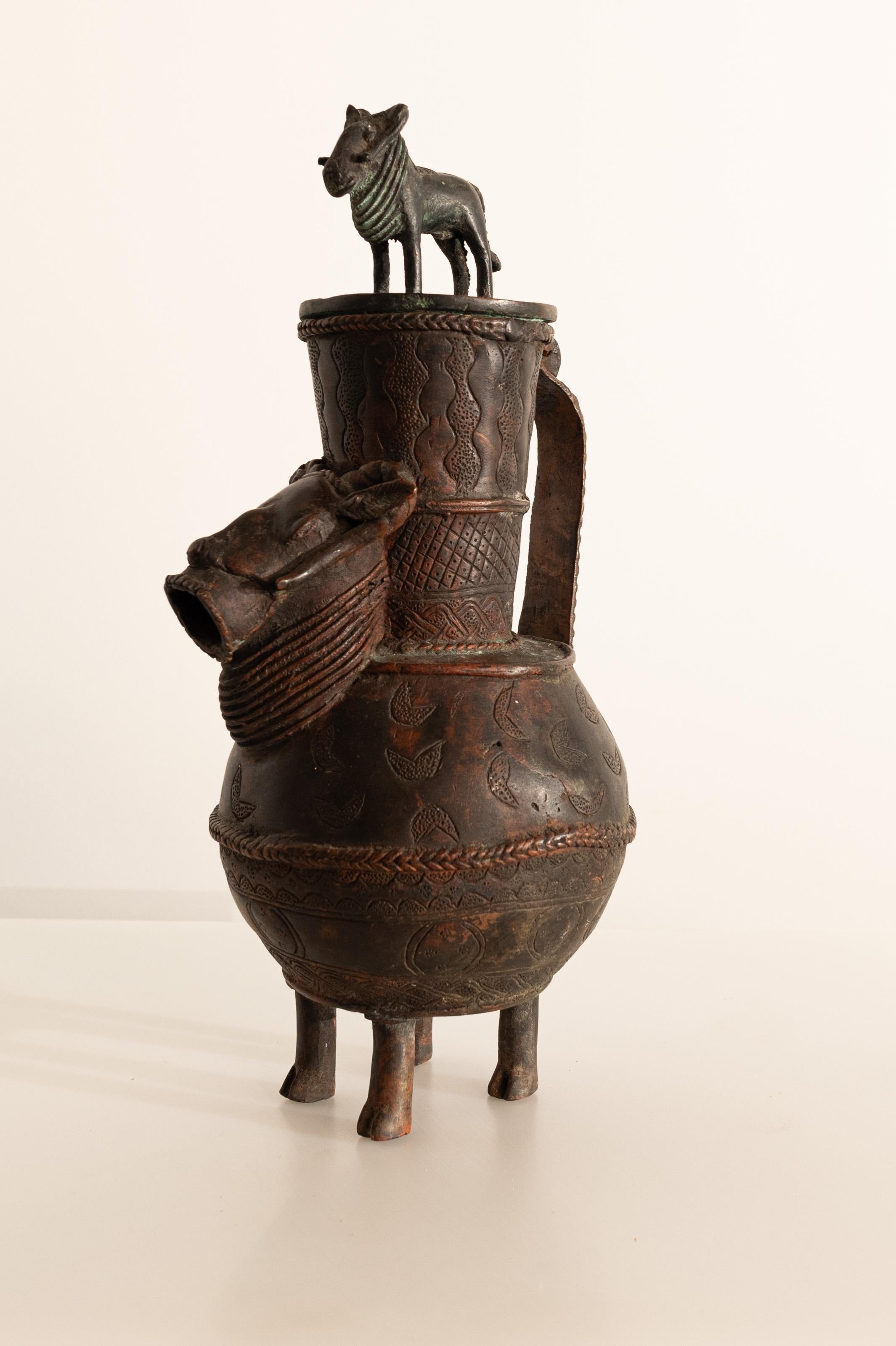 Bronze ceremonial jug from Benin (late 19th - early 20th century) with intricate details and bold animal motifs. 