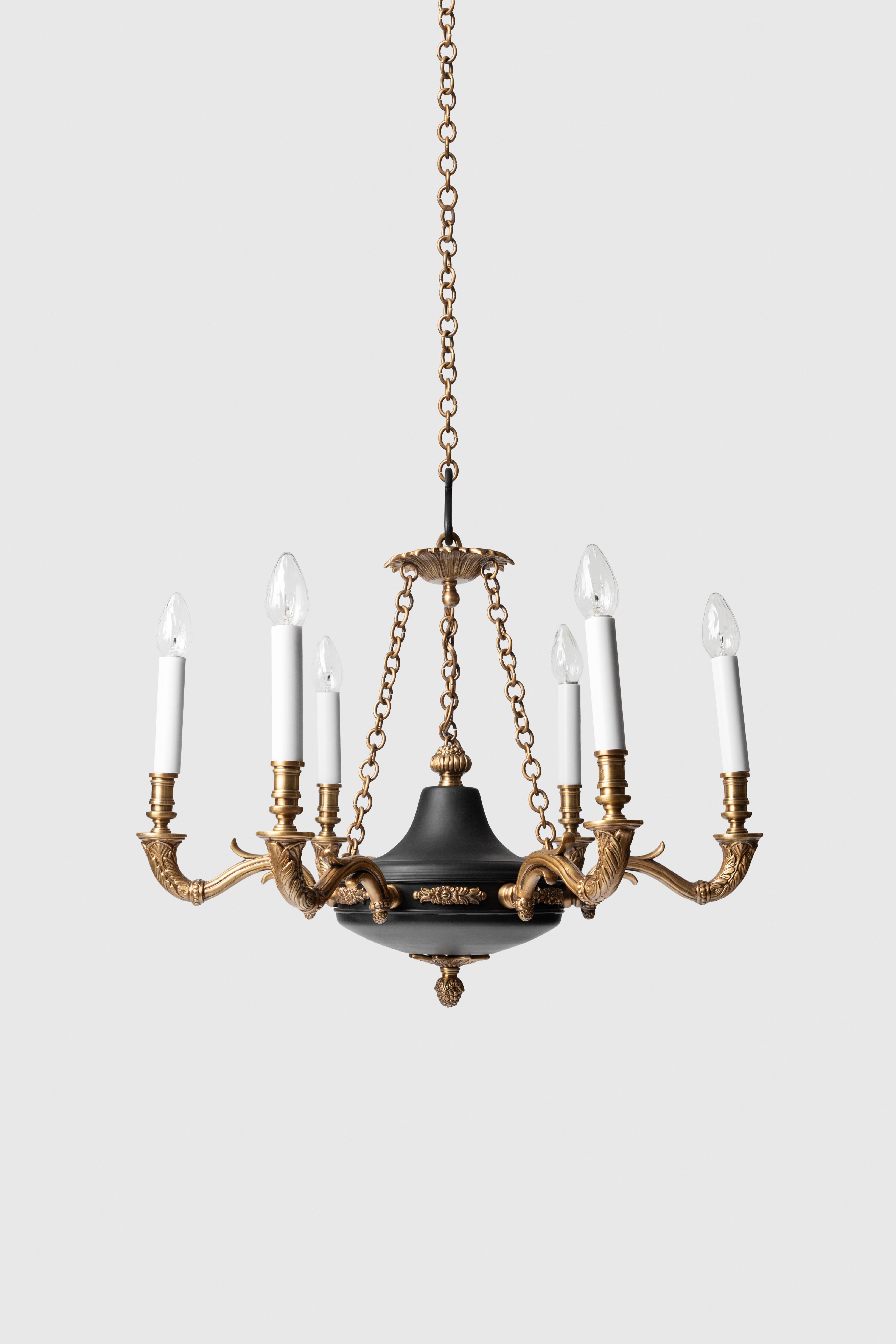 Six light chandelier made in bronze with black and gold finish. Acorn details in gold.
