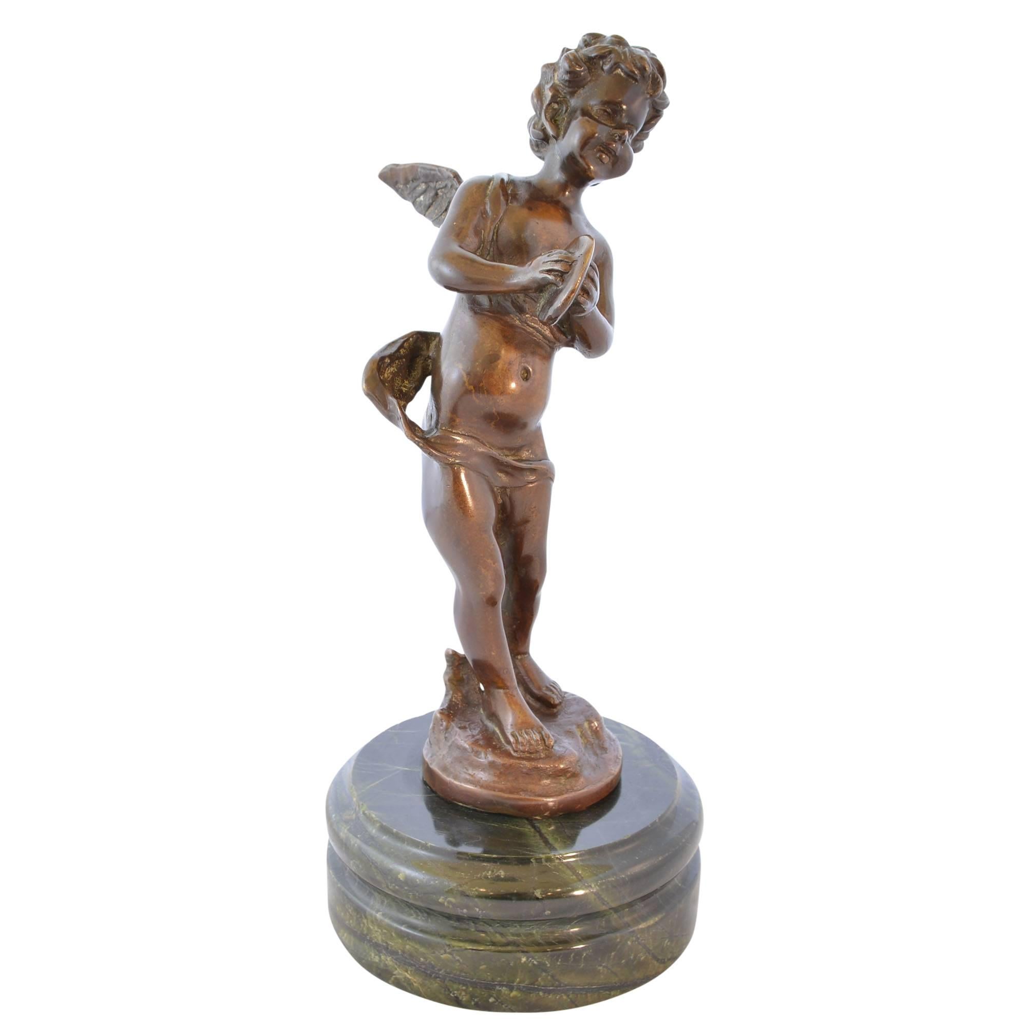 Bronze depiction of a cherubic figure clashing cymbals, a recast after a work by French artist Auguste Moreau (1834-1917). The joy of the music is seen in his face and movement. It rests upon a heavy green marble base and is signed to