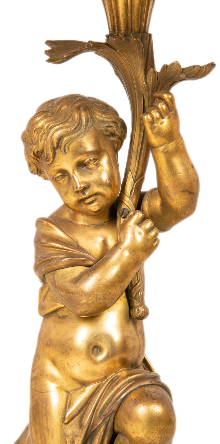 A good quality classical gilded bronze cherub supporting marble topped side table, raised on a plinth base.