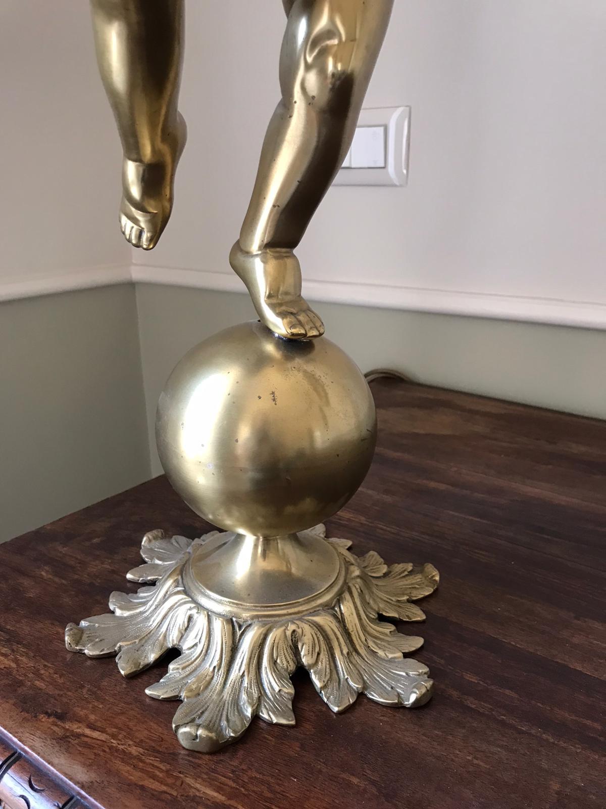 Elegant Italian Cherub statue in bronze holding a  with five arms chandelier  adorned by crystal drops 
** in excellent vintage condition
* the shades are new