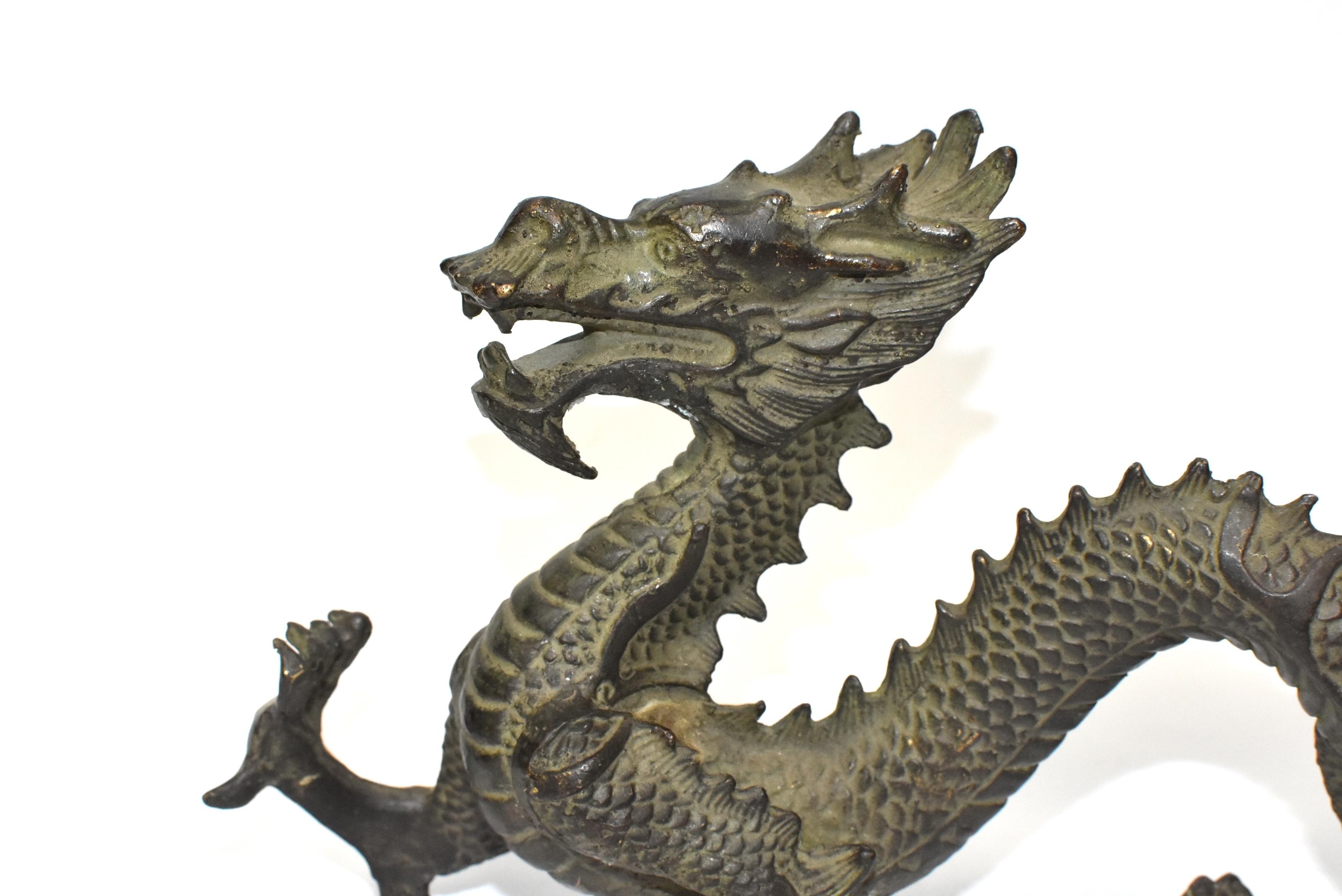 A beautiful bronze dragon with fantastic depiction of horns, scales and paws. The dragon is the sign of Chinese Emperor, it symbolizes power and prosperity. A wonderful piece as a gift, a display or a feng shui tool.
