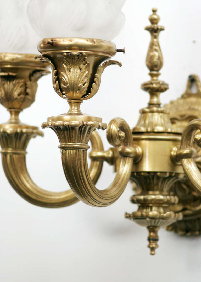 Heavy solid bronze classical revival wall sconce with 3 tier single electric light sockets. Comes with matching French torch milk glass globes.
