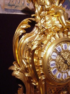 Bronze clock featuring enameled plaques with Roman numerals