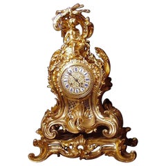 Antique Bronze clock featuring enameled plaques with Roman numerals