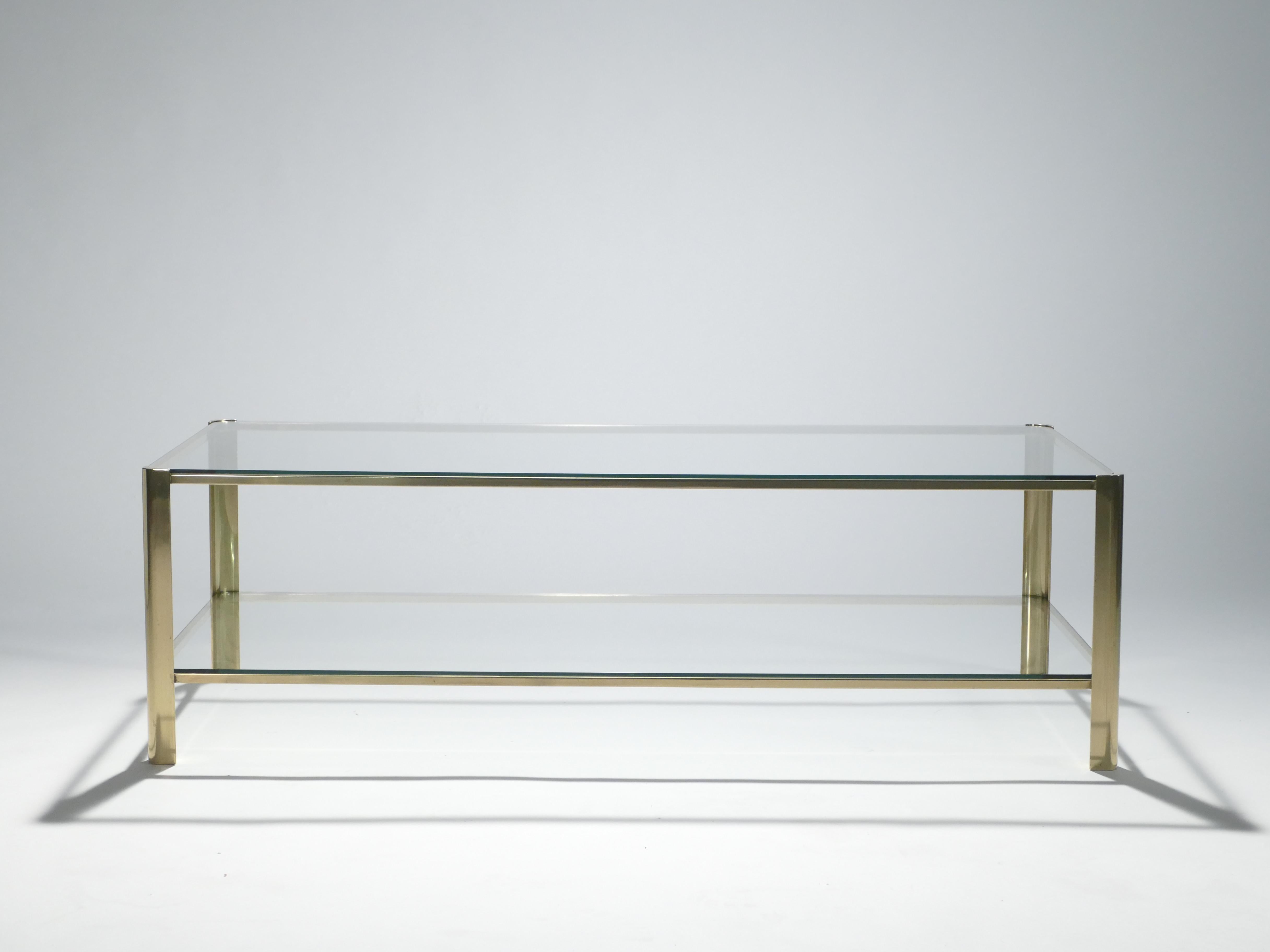 This coffee table signed by Jacques Quinet and stamped by Broncz, is a remarkable find. It features a strong, bronze base constructed to last. The 2/3 glass top adds extra storage space as well as aesthetic appeal. This coffee table will not only be