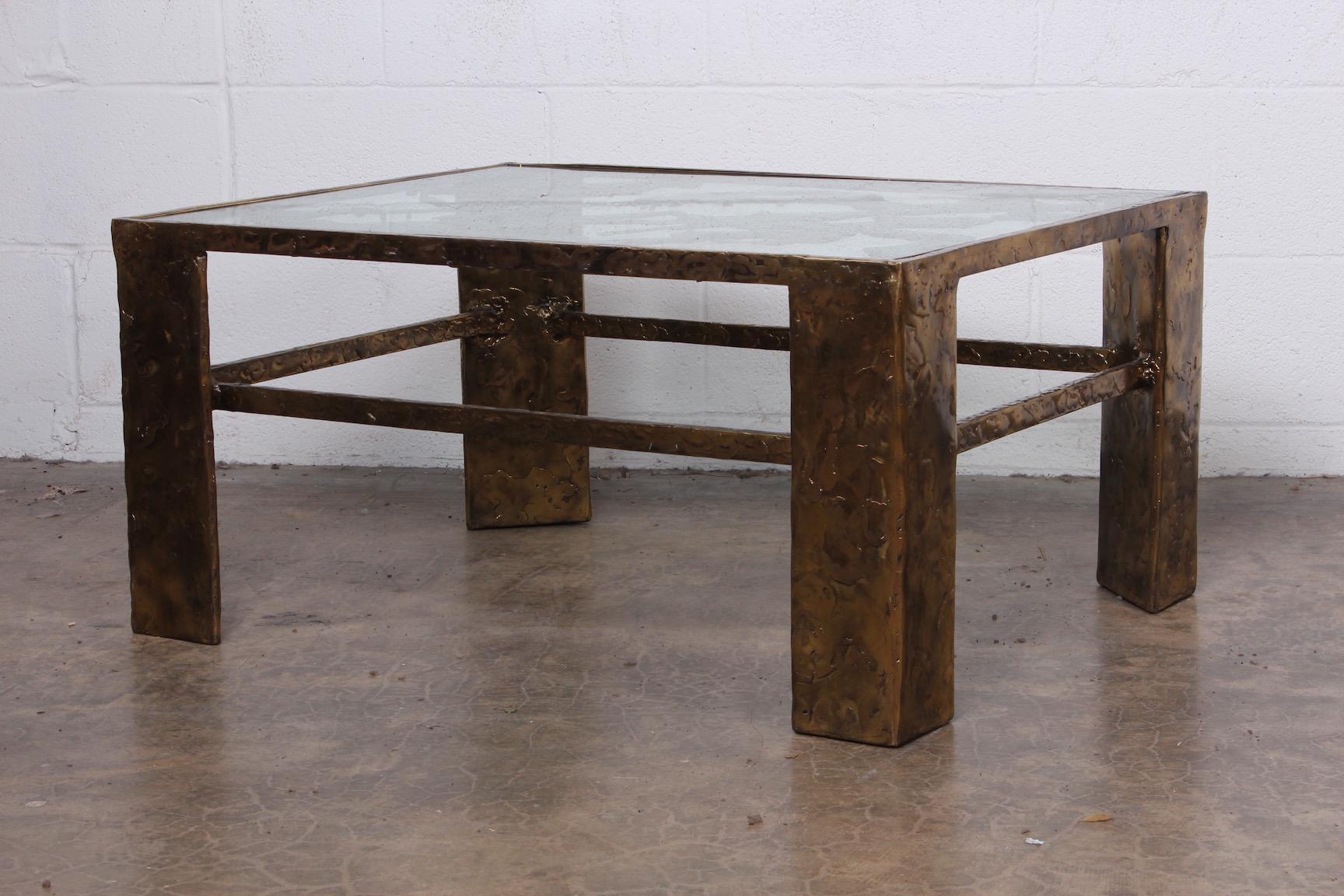 A bronze and glass table by Silas Seandel.