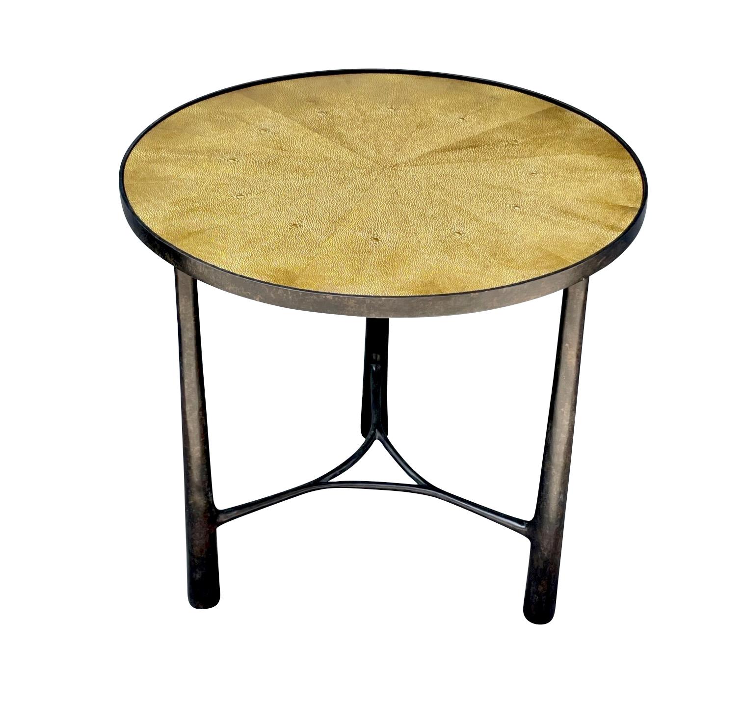 Contemporary German bronze coffee table with a gold faux shagreen top.
Three tubular legs.