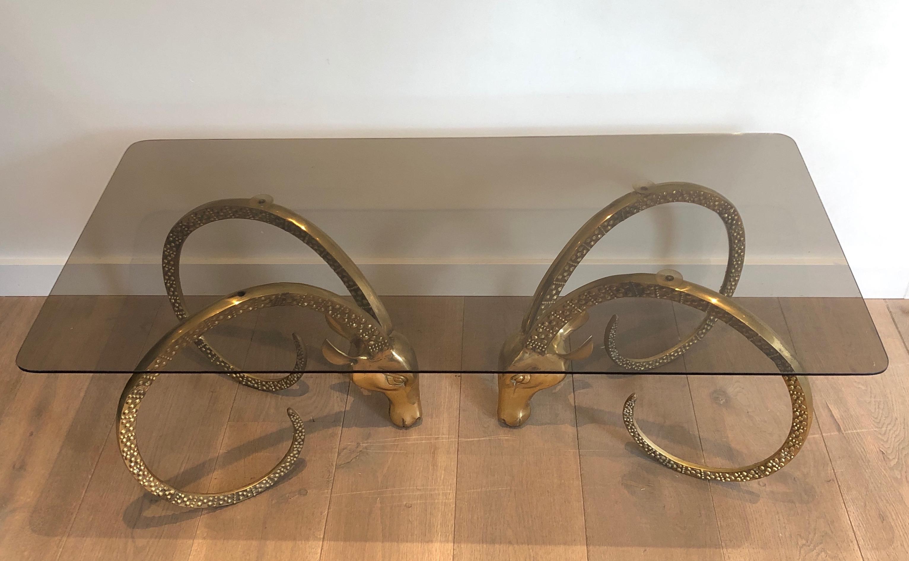 This very nice coffee table is made of bronze. The cocktail table represents 2 Ibex heads that are part of the base. This is a French work by Alain Chervet. Circa 1970.