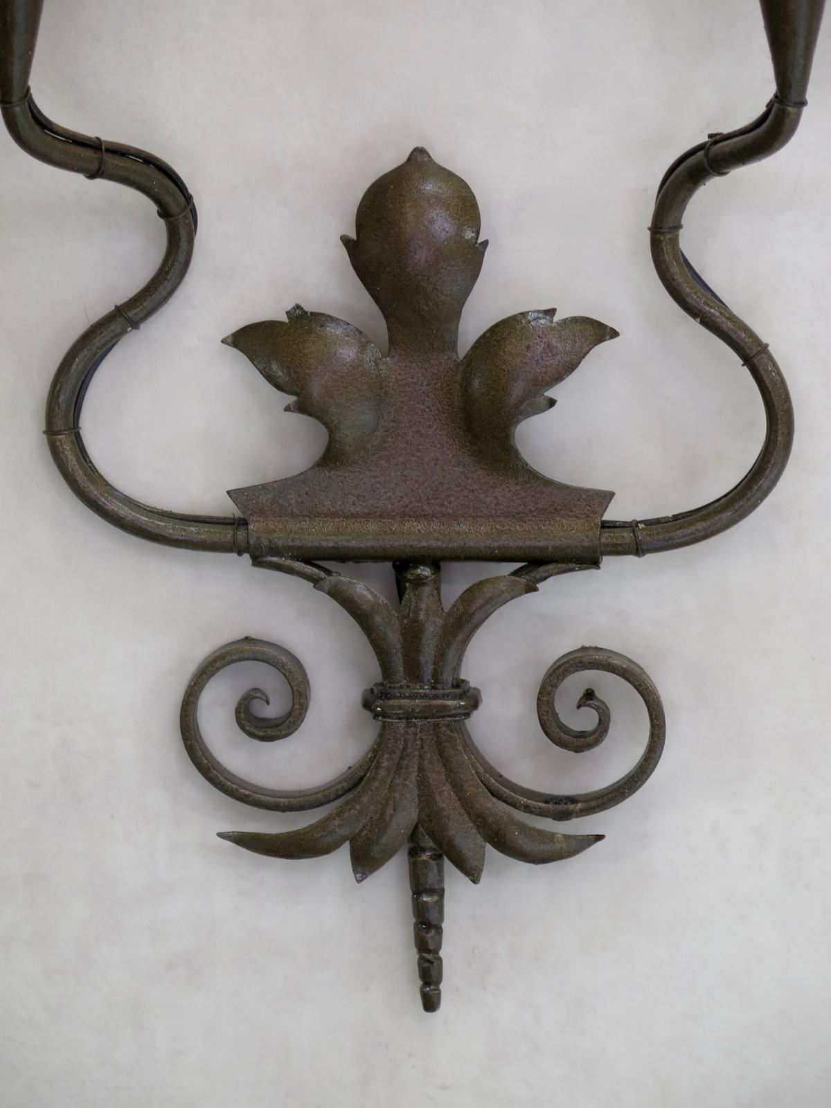 Tall wall light, with cut-out acanthus-leaf motif, and painted with a bronze-colored finish.