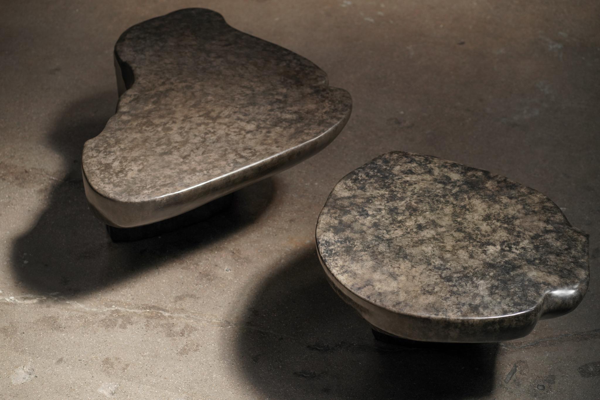 A striking bronze coffee table duo, each piece uniquely cast with complementary forms and rich, dark patina. Designed to sit together as a sculptural centerpiece or stand alone with individual presence.