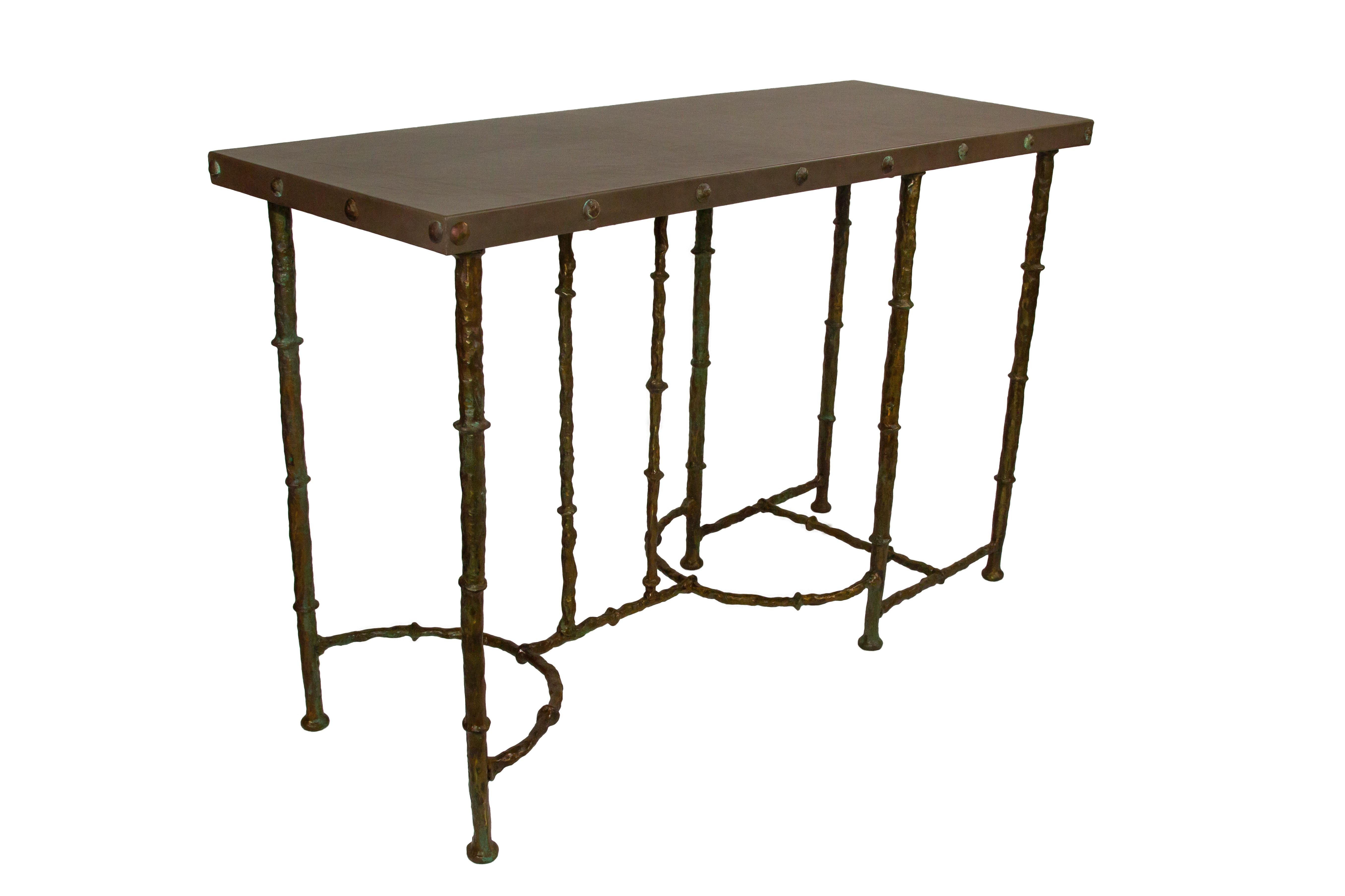 The hand-sculpted bronze console is a hand forged and handcrafted edition with leather top or glass or stone , fastened by bronze sculpted nails; each piece is numbered and stamped. Custom sizes and finishes available.