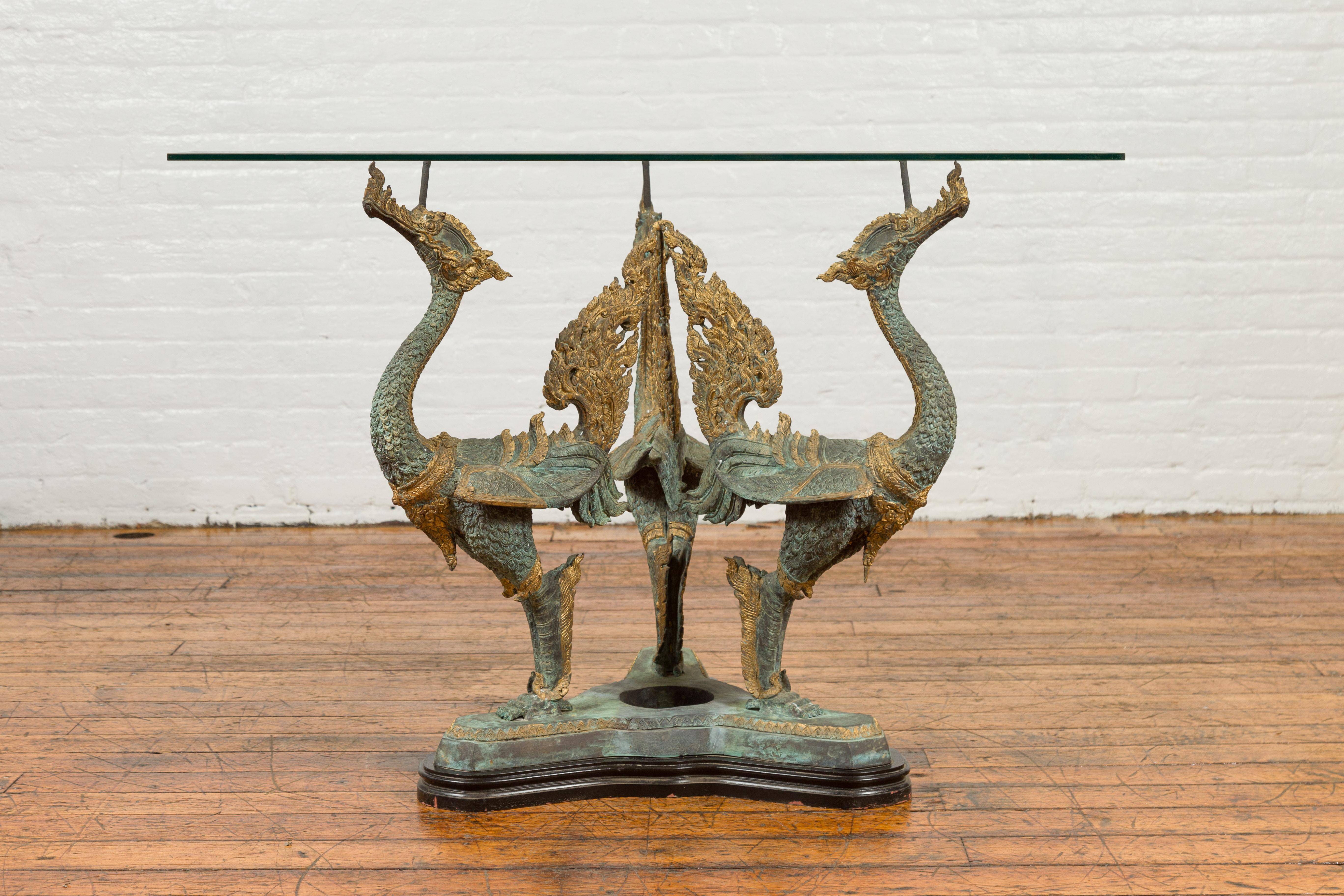 A contemporary triple dragon table base with verde patina and gilded accents. The table top is not included but shown on the photos to allow better visualization of the possibilities. Created with the traditional technique of the lost-wax (à la cire