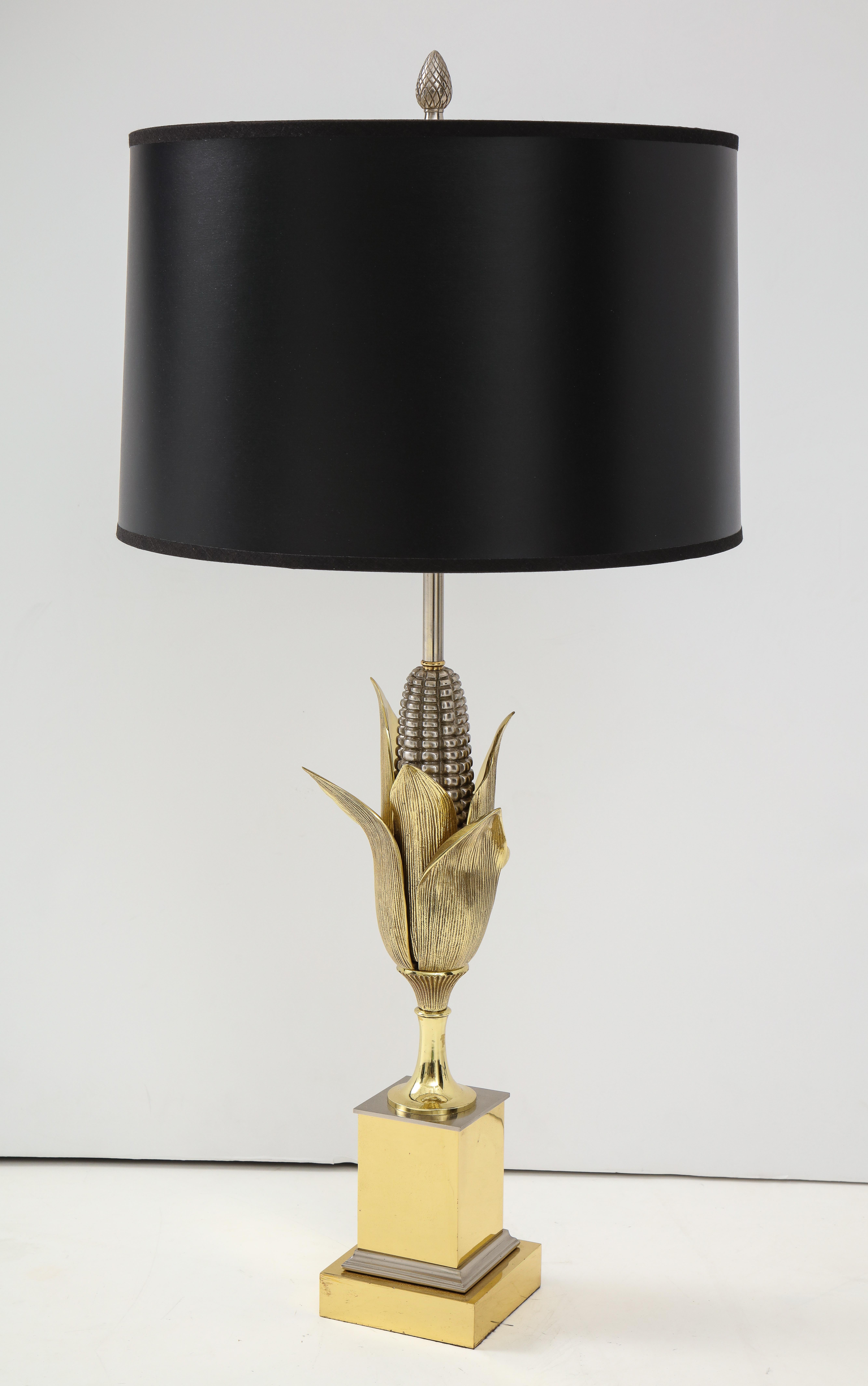 Bronze corn lamp raised on stepped plinth base.