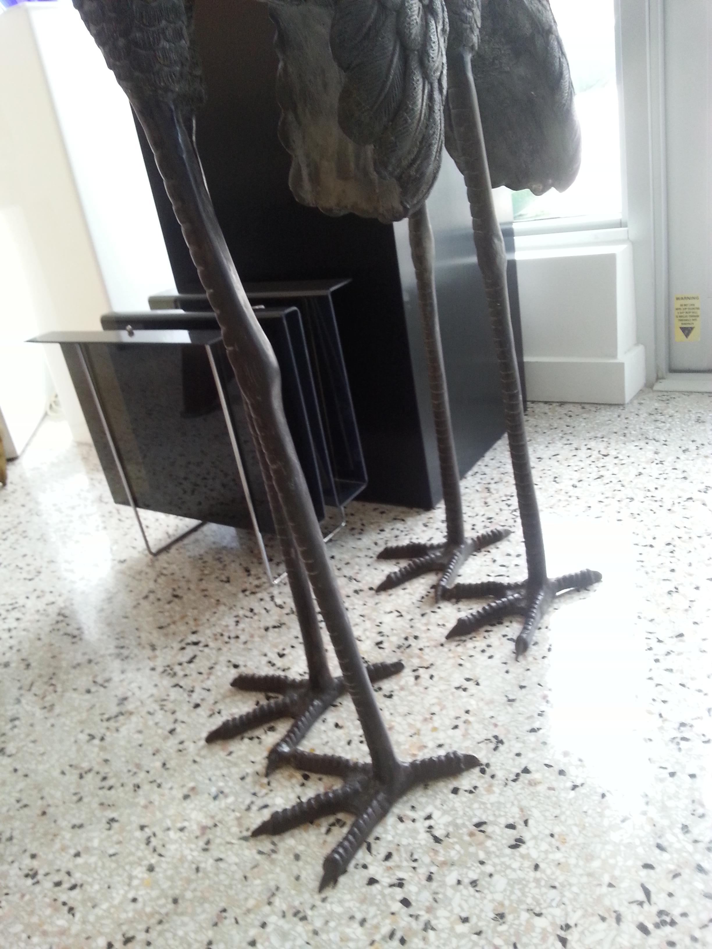 This large scale, stylish and chic pair of bronze cranes sculptures were acquired from a Palm Beach estate. 

Measures: Male 70.63 H x 12.5 W x 16.75 D
Female 58.25 x 13 W x 18.13 D.

Note:  The back toe (claw) of the shorter crane has been restored