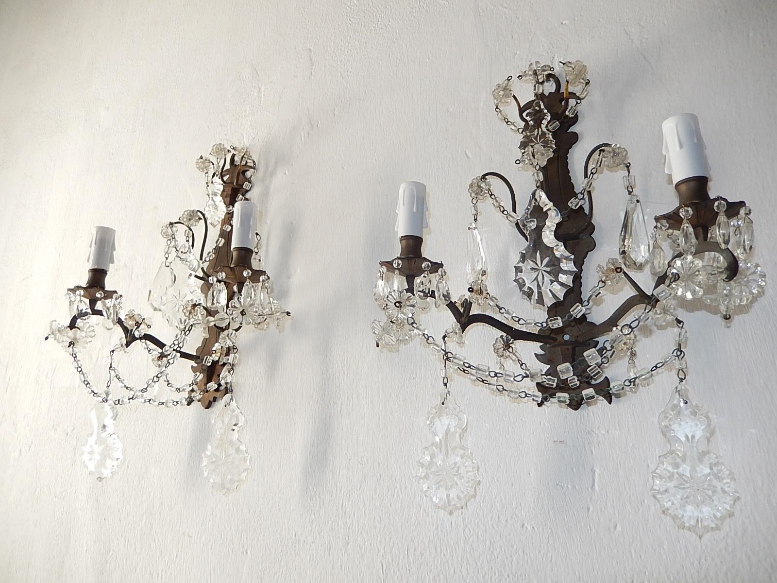 Housing two lights each. Rewired and ready to hang. Bronze body with perfect patina. Swags of macaroni beads and florets throughout. Adorning cut crystal prisms with stars in centre. Free priority shipping from Italy.
