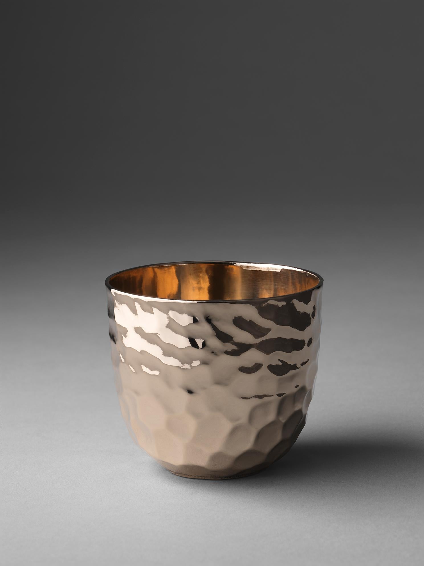 A bronze cup. The hand-wrought exterior contrasts nicely to the smooth inner wall. The lip is 2mm for fine sipping. It holds 125ml