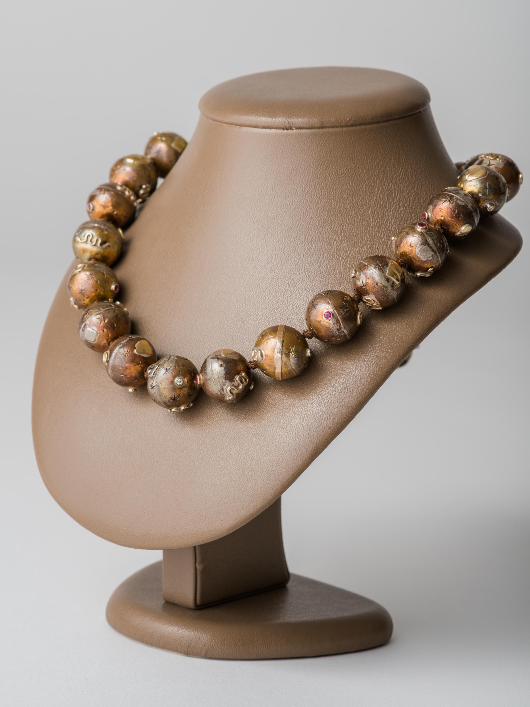 Handcrafted bronze bead necklace with ball catch, keyhole closure and figure eight safety catch by NYC jewelry artist Mark Timmerman. The necklace consists of thirty 17mm bronze beads, each adorned with six elements including fifteen 2 pt. diamonds,