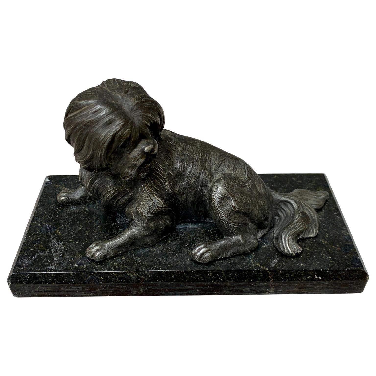 Mid 19th century bronze dog paperweight perched on beveled black marble base. The detailing of the dog's hair and body is exquisite. This sweet little piece is perfect as a desk accessory, bookend, or sitting alone gracing a shelf. Functional and