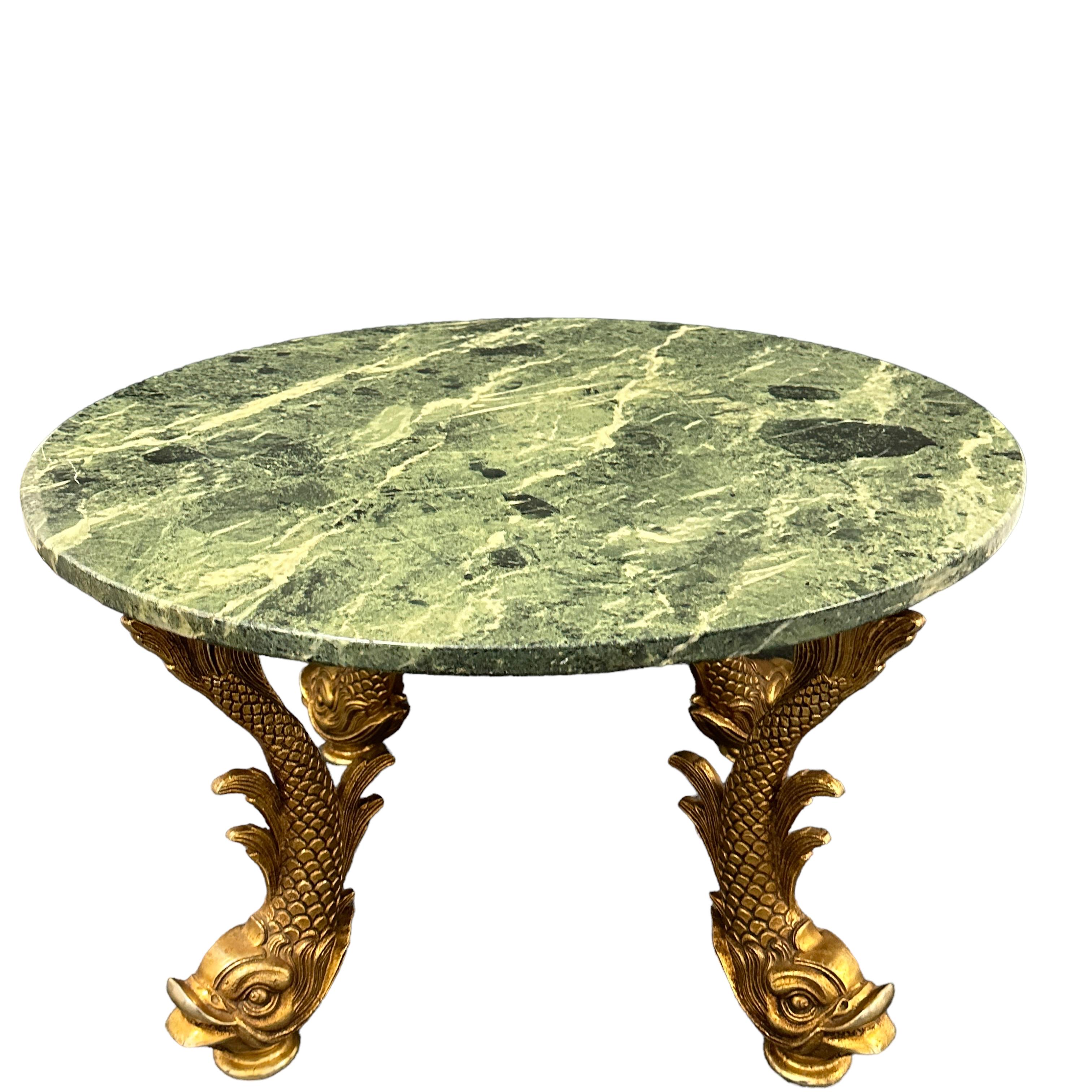 Offered is a 1980s Cocktail Coffee Table gilt bronze Koi or Dolphin Base Organic Design green marble Top nice for a Palm Beach house.
This stylish and chic Hollywood Regency inspired cocktail table dates to the 1980s and will make a definite