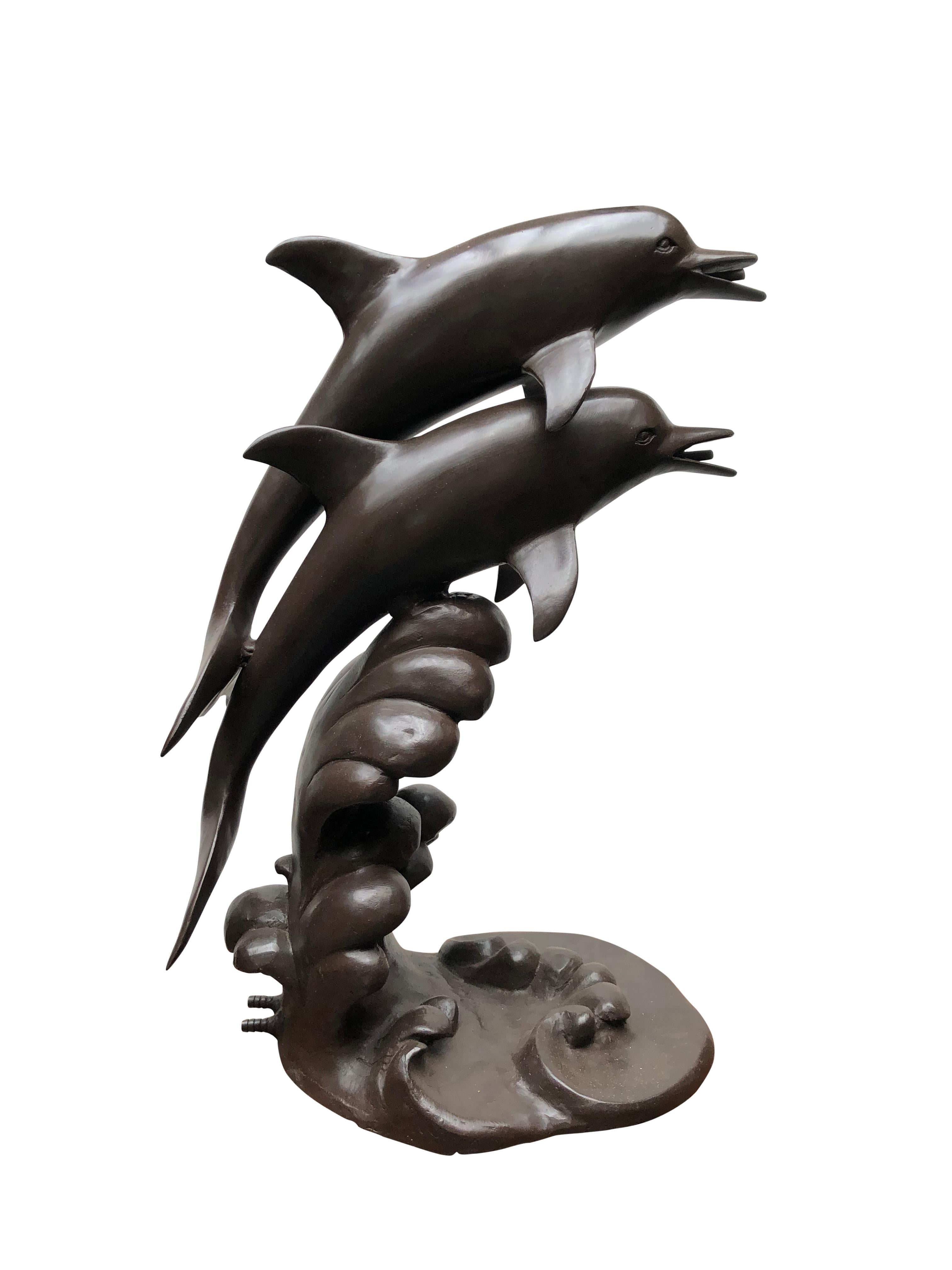 A stunning bronze Dolphin Fountain Garden Art, 20th century. Great for a pond or ornamental feature. Two dolphins each with a water spout in the mouth and at the base. Patina to the bronze is superb and this is offered in excellent shape. Of course