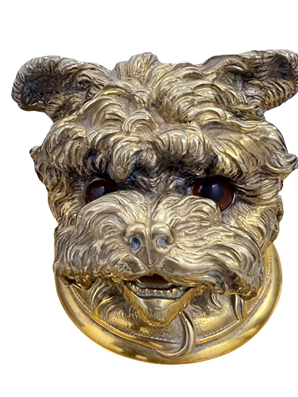A round bronze doré dog inkwell with a hinged top and brown glass eyes. Circa 1900, England.