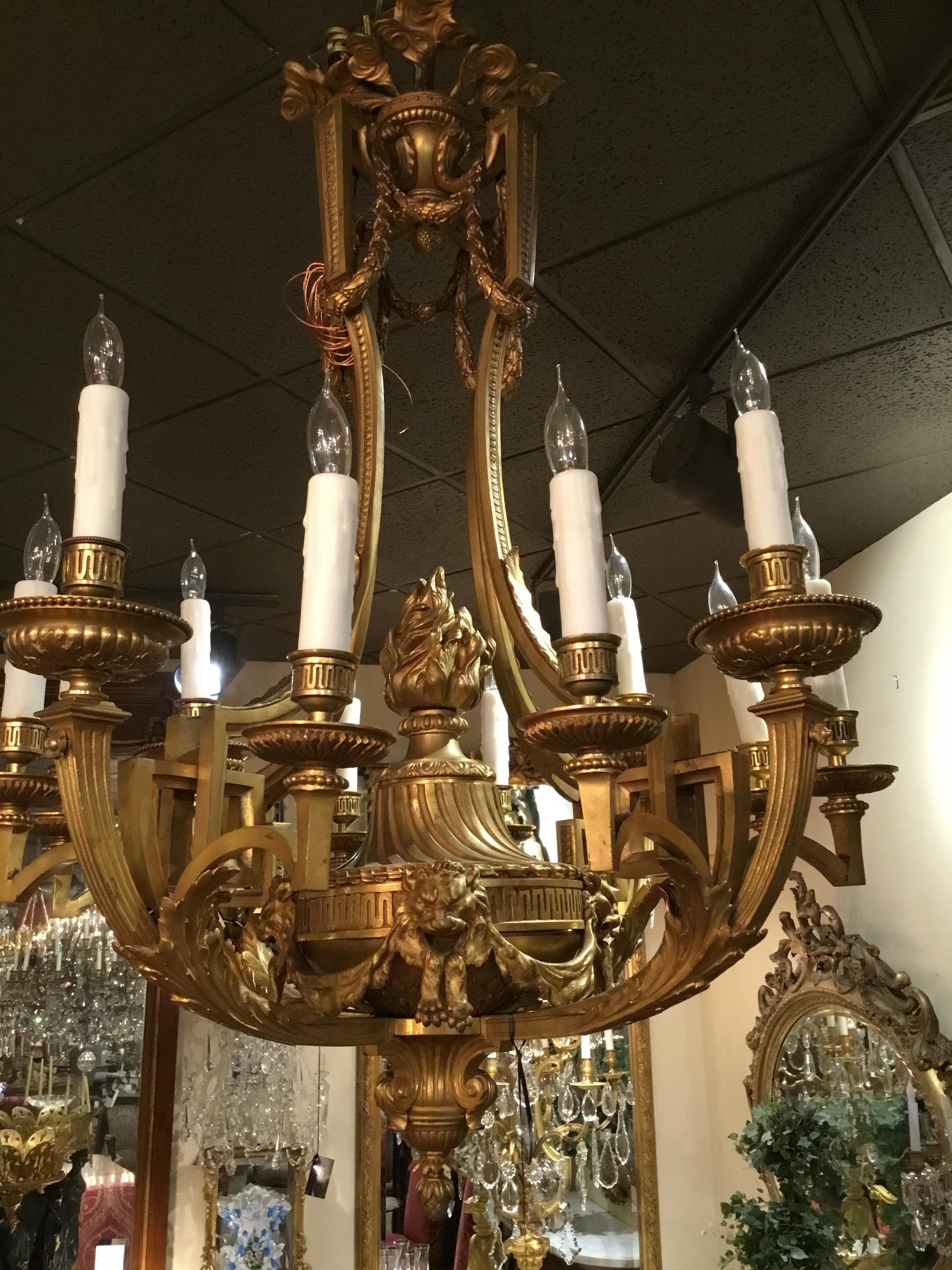 Exquisite chandelier with elongated curved lines, featuring lion masks and a center
Torch.