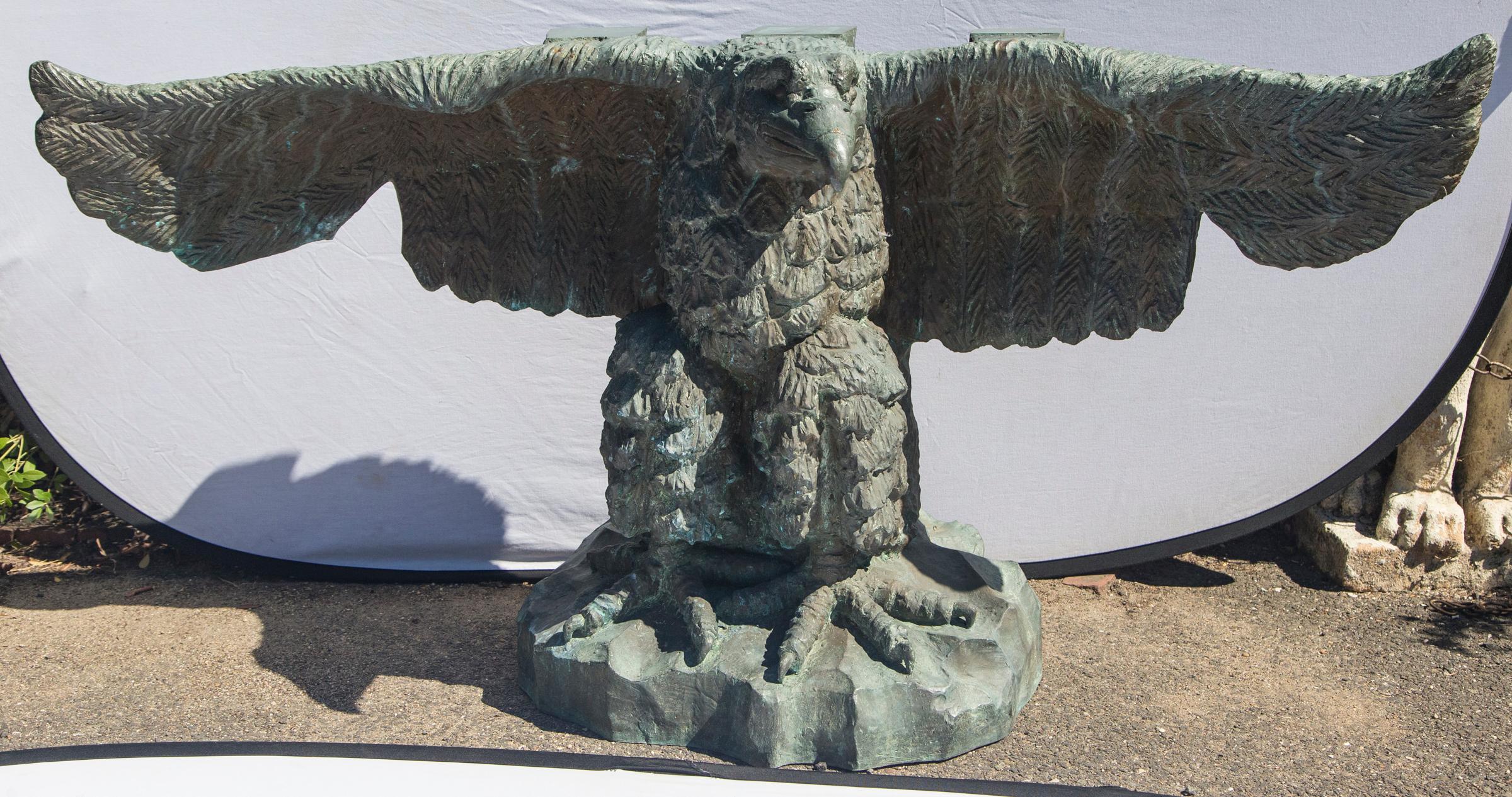 An extraordinary base of a spread wing eagle. The wing tips and 3 blocks of bronze support whatever sits atop. It is signed Victor M Salomes (?)and dated 67 on the back side of the rock formation upon which it stands. Each feather is visible from