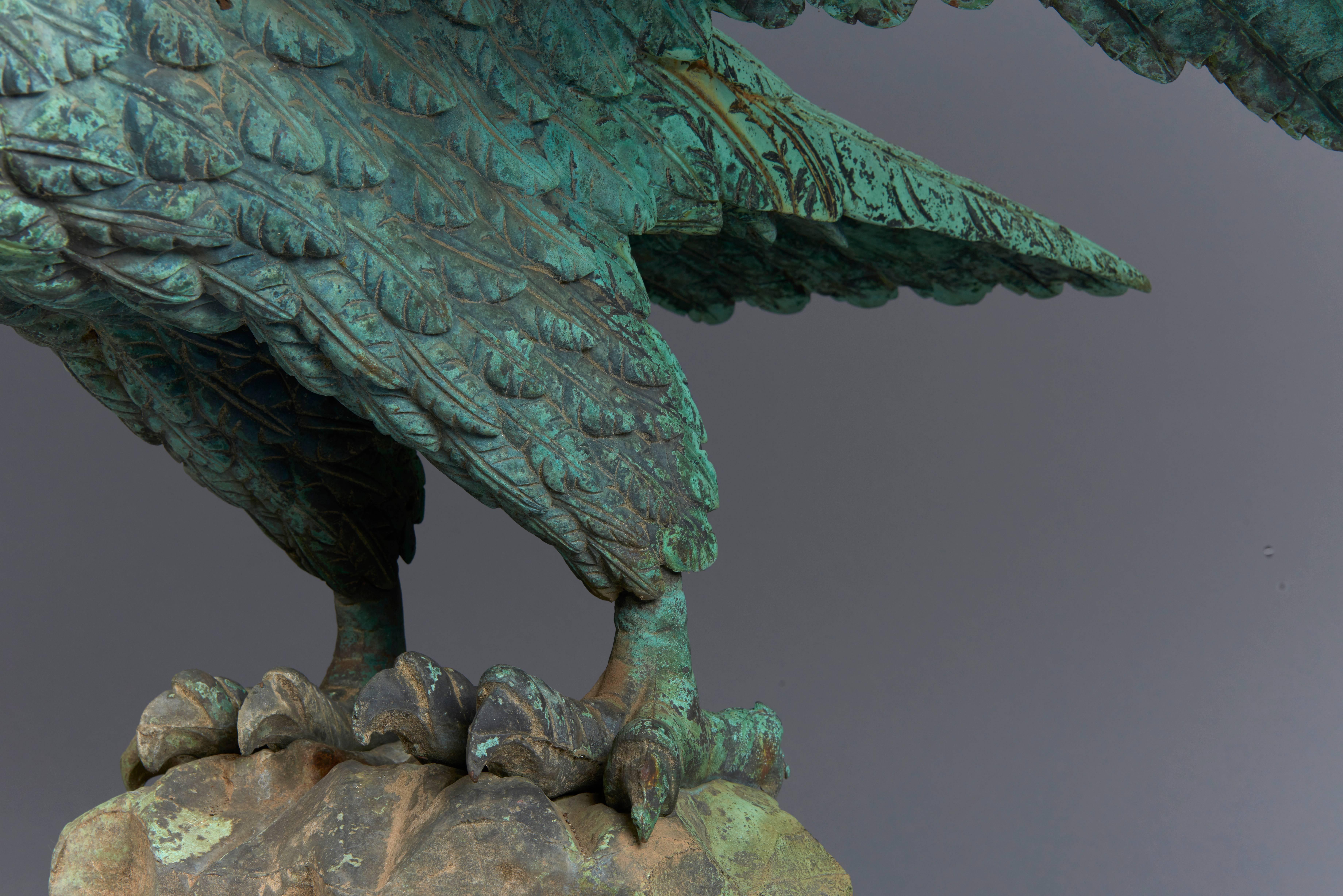 A finely carved eagle cast in bronze with an all over great patina. Manufactured in the 1880s, the golden age of American architectural and garden ornament when companies like F.W. Fiske, Mott and others in the northeast and midwest flourished,