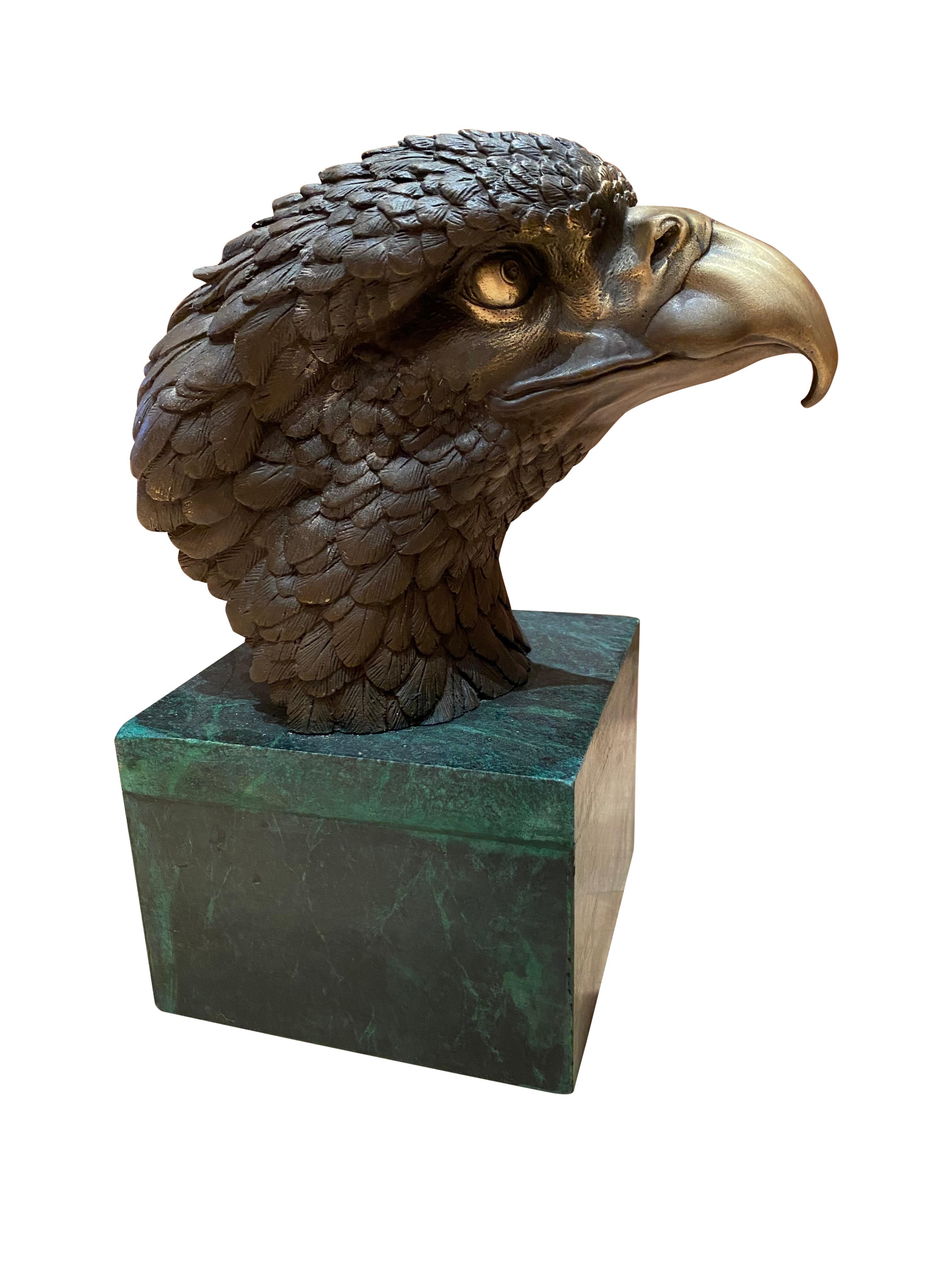 A fine quality bronze eagle head sculpture, 20th century. Stands on a verdigri proportionate square marble base. This piece is offered with excellent detail and sharp points of view.
