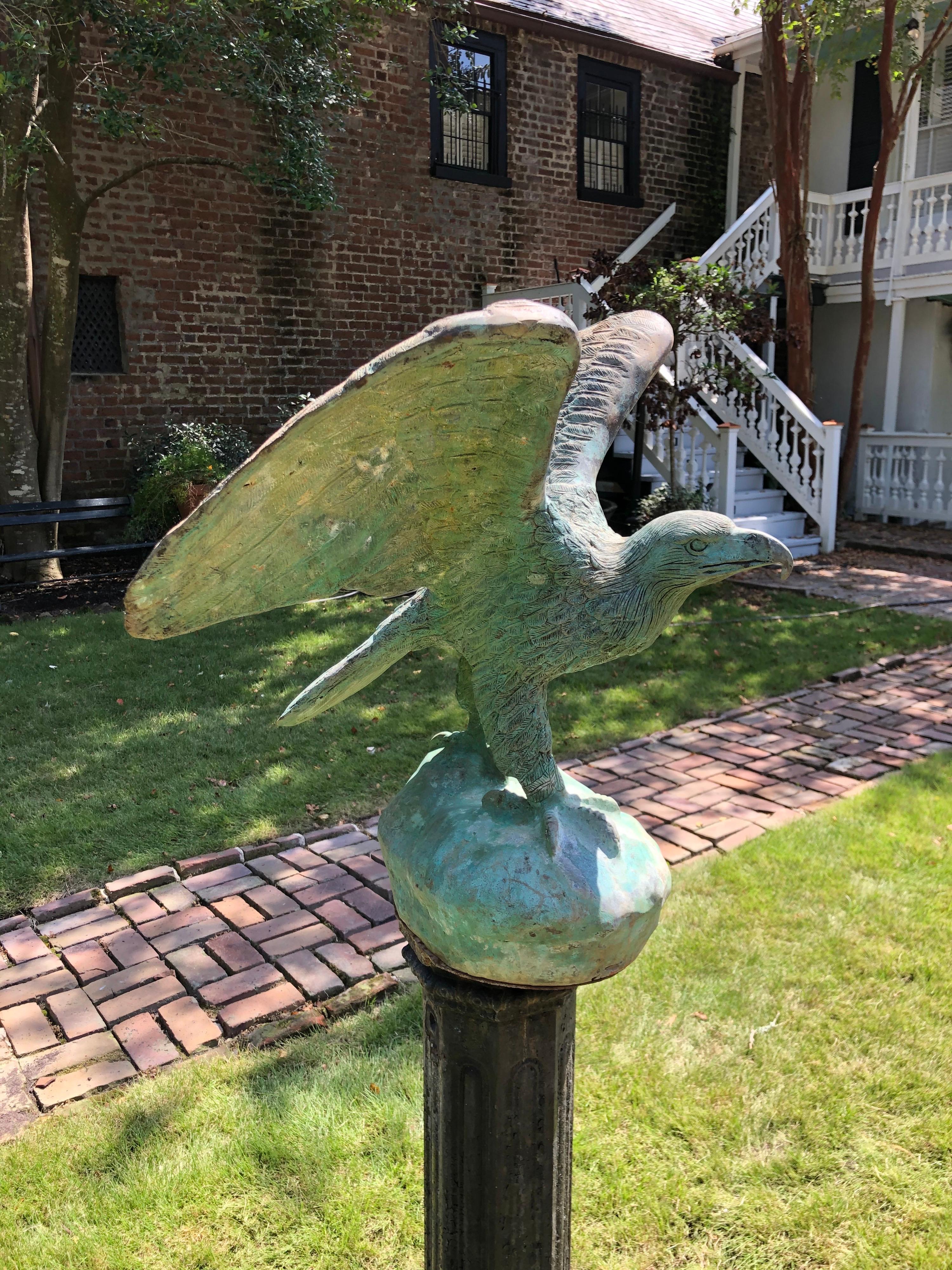 This bronze Fiske eagle on iron pedestal has fine detail with a great verde patina. 
Eagle Measurements: 26.5 inches H. by 23 inches W. by 22 inches D.
