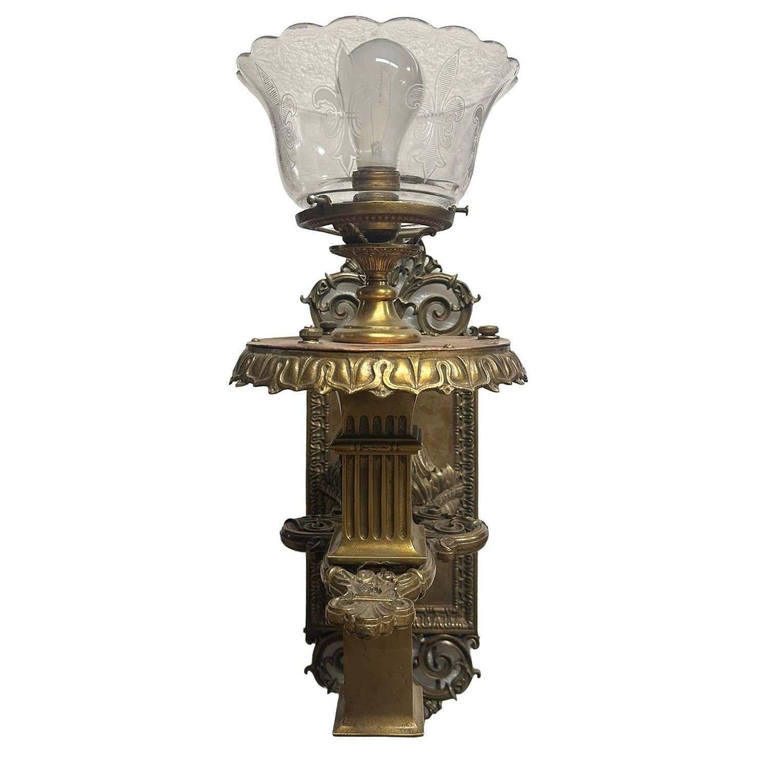 This solid bronze Edwardian torchiere wall sconce exudes timeless elegance with its classic silhouette and rich patina. The candle holder, styled like a Roman column, adds a dignified touch with its fluted design, bringing to mind ancient