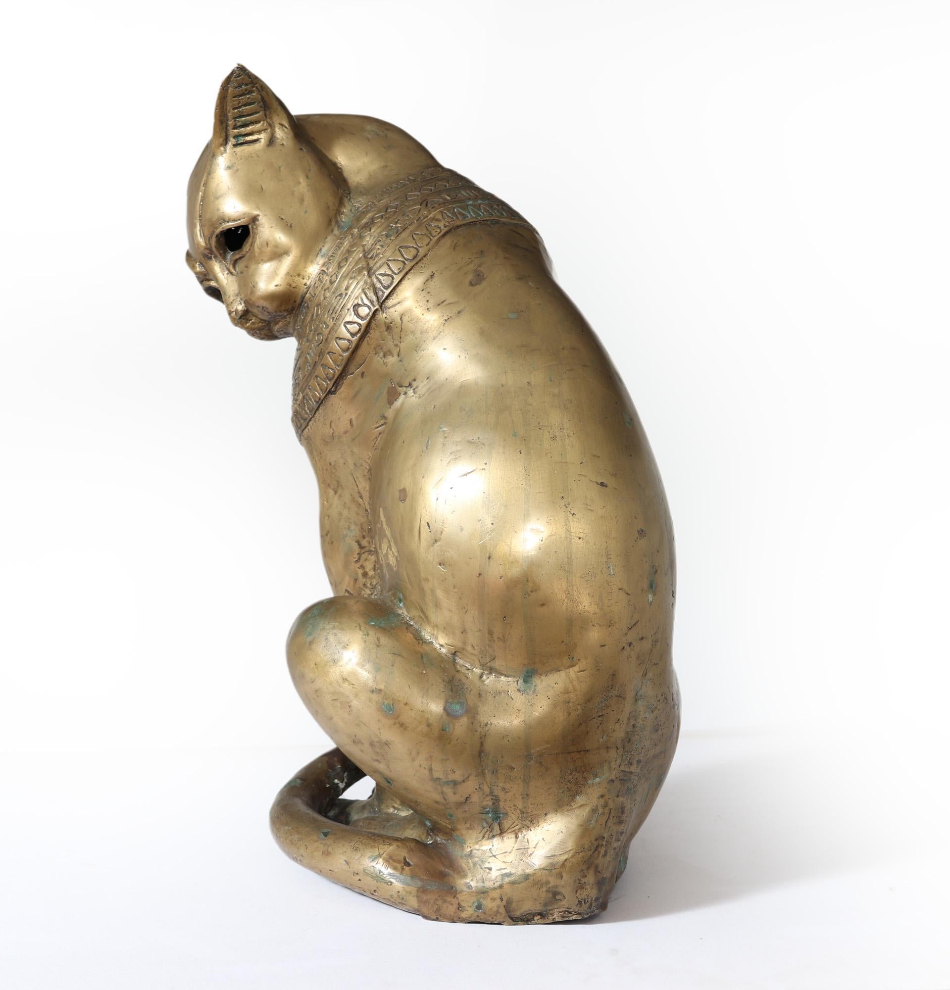 BRONZE EGYPTIAN CAT GODDESS 
A rare and stylised gold patinated solid bronze cast cat god ‘Bastet’ with hollow eyes produced in the Art Deco period, having beautiful for the cat stands beautifully, having a thick collar with Egyptian hieroglyph the