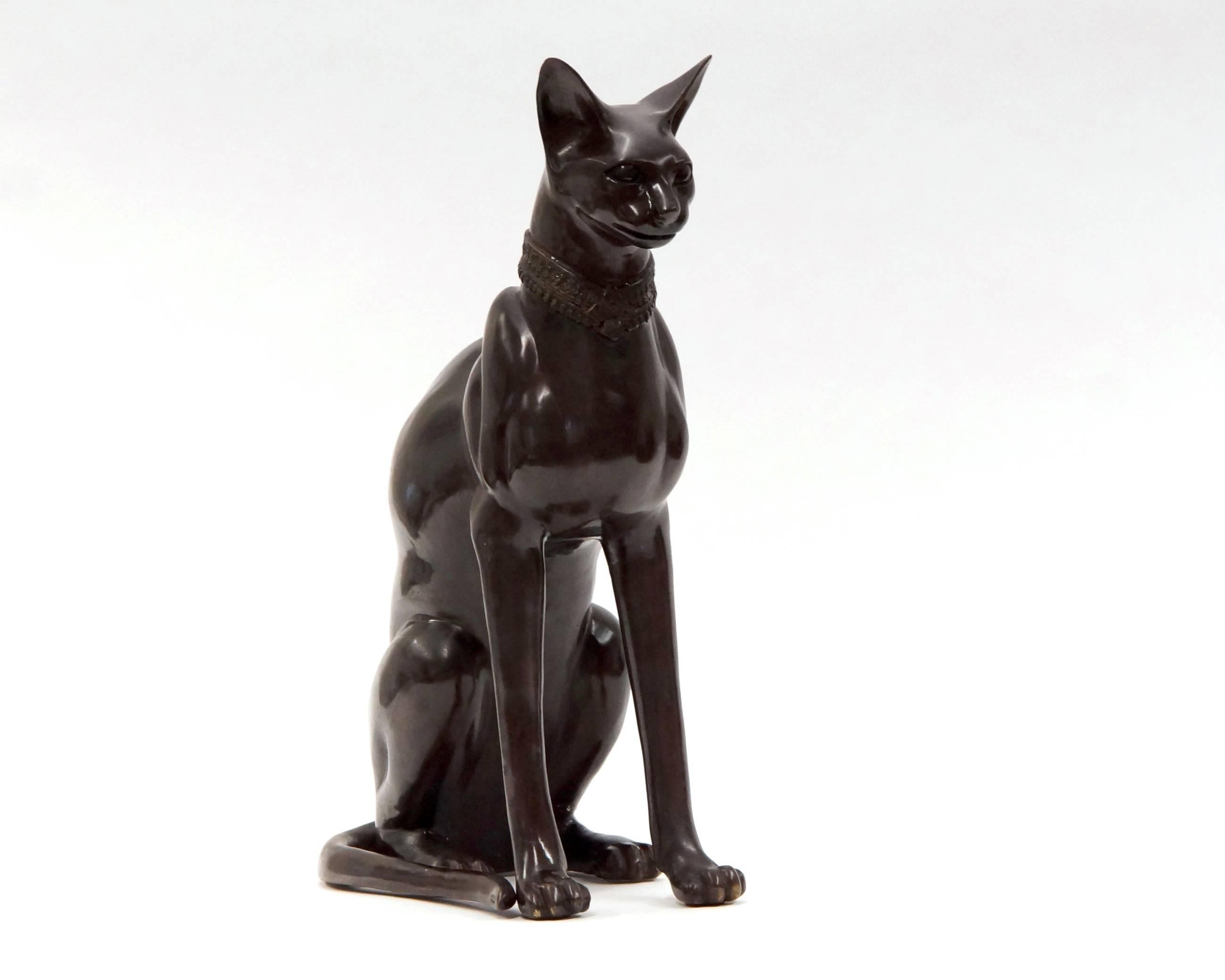 Beautiful bronze Egyptian cat, signed by A. Tiot. This beautiful piece will make a great stand in any room. The massive height of 61 cm makes this cat feels a new roommate for your home. The cat was bought in the 1970s and has a great patina. The