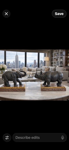 Bronze elephant by Theodore Alexander on rococo style rose granite base