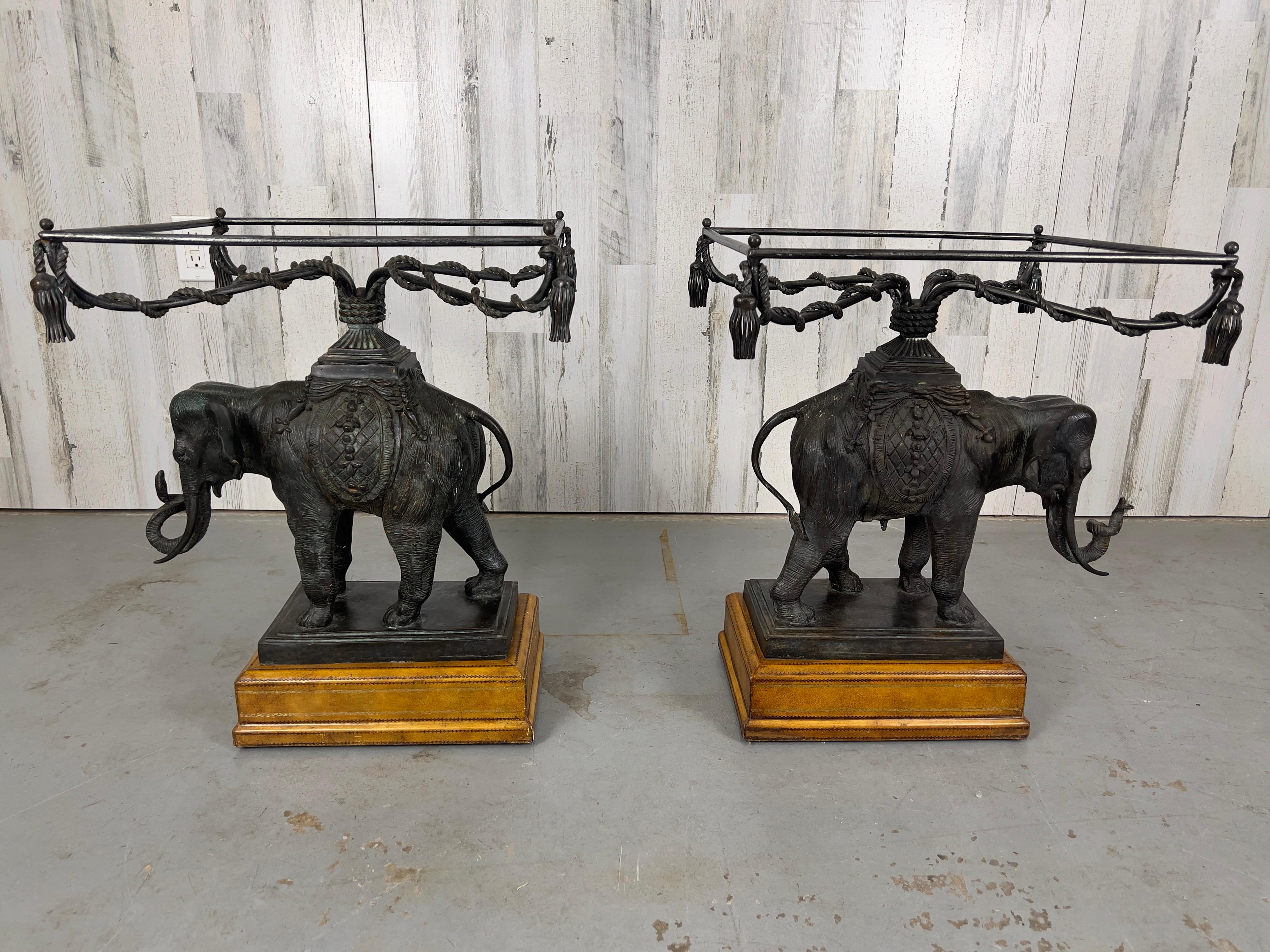 Pair of bronze elephants with glass tops mounted on gold leaf tooled leather plinth.
Top quality attributed to Maitland Smith.