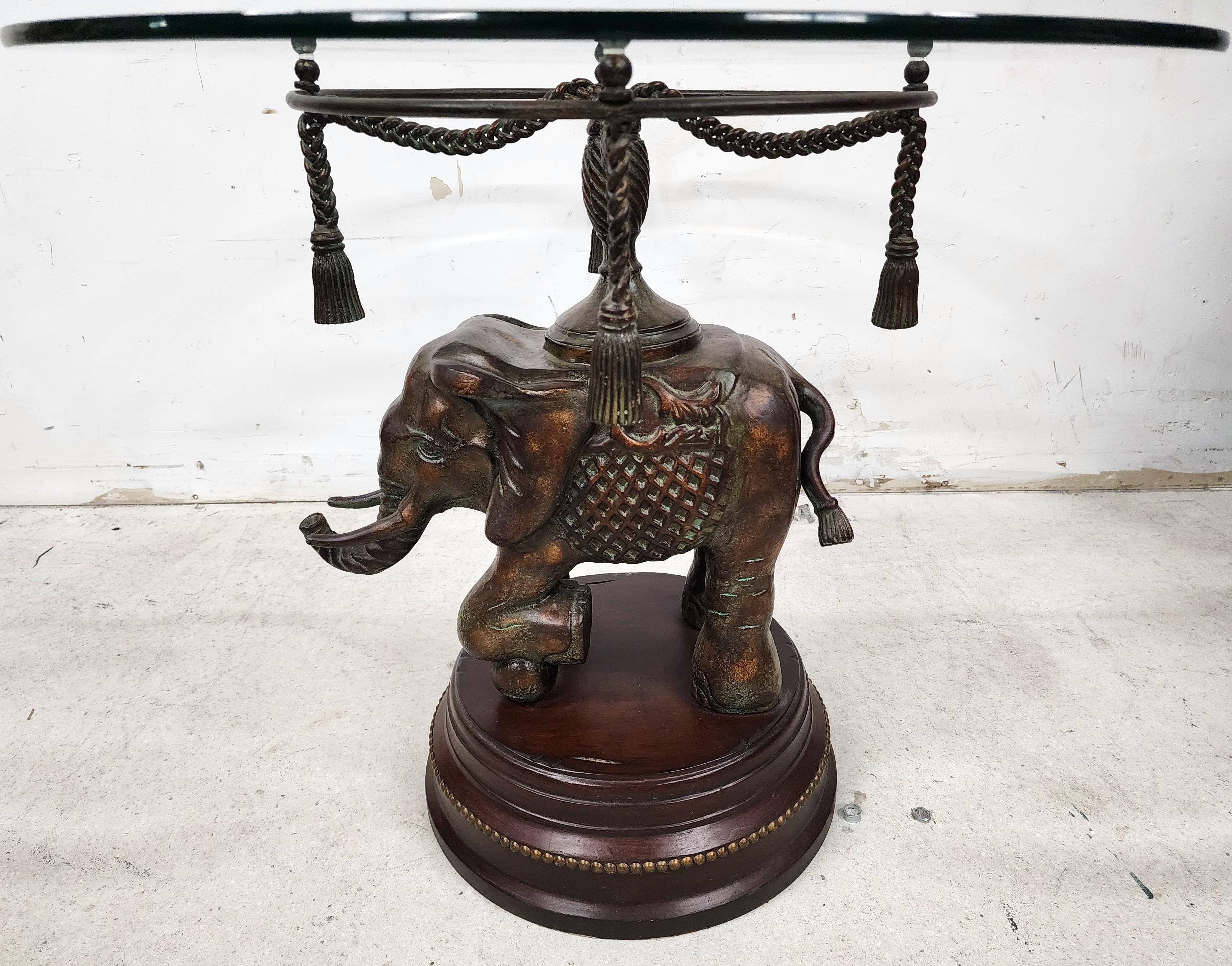 For FULL item description click on CONTINUE READING at the bottom of this page.

Offering One Of Our Recent Palm Beach Estate Fine Furniture Acquisitions Of A
Bronze elephant standing on a carved wood plinth with decorative brass nail head trim.