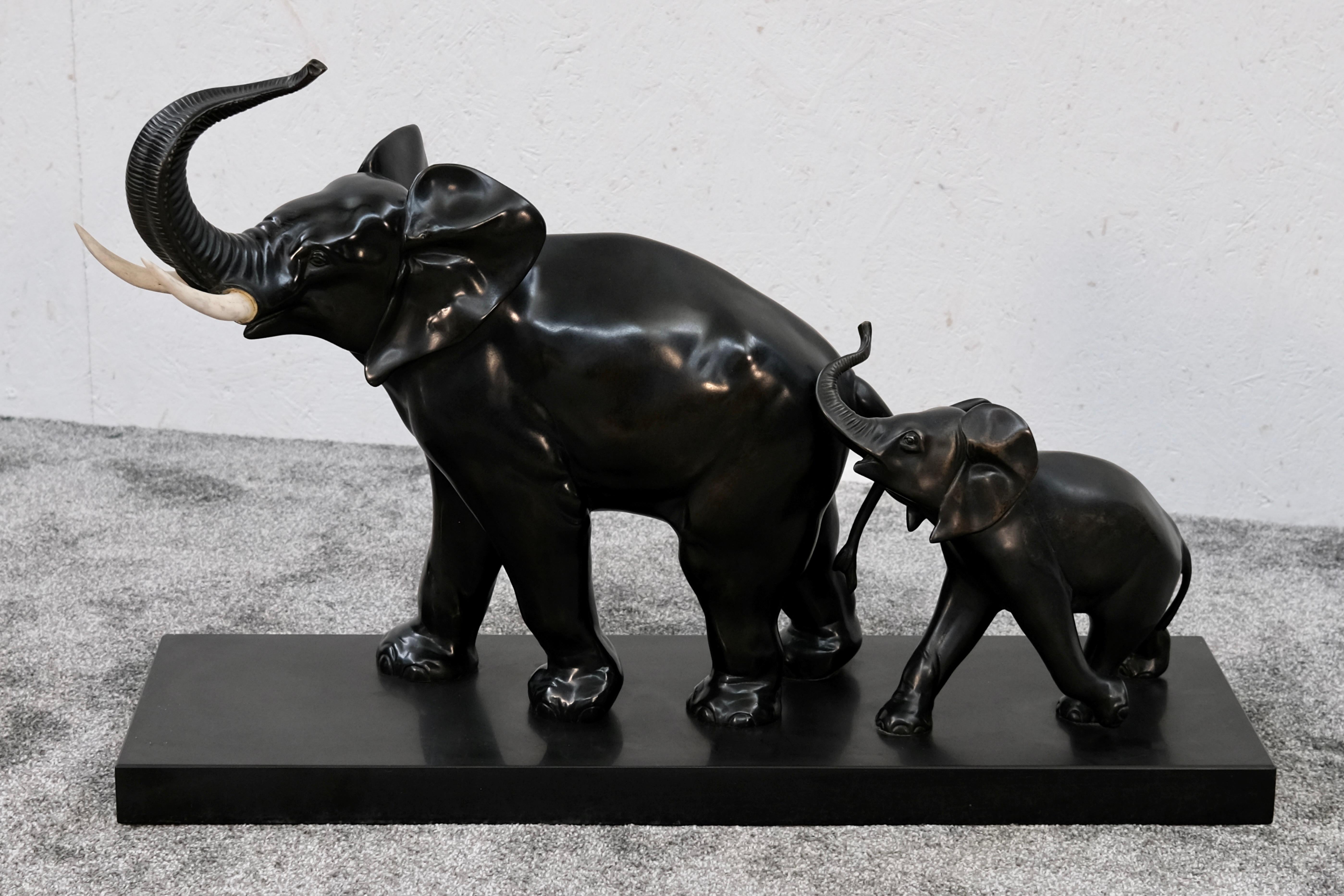 This expressive Art Deco bronze sculpture by Irénée Rochard captures a tender moment: a mother elephant and her calf, lovingly connected in movement. The calf’s trunk gently touches the flank of the adult, a detail that adds warmth and emotional