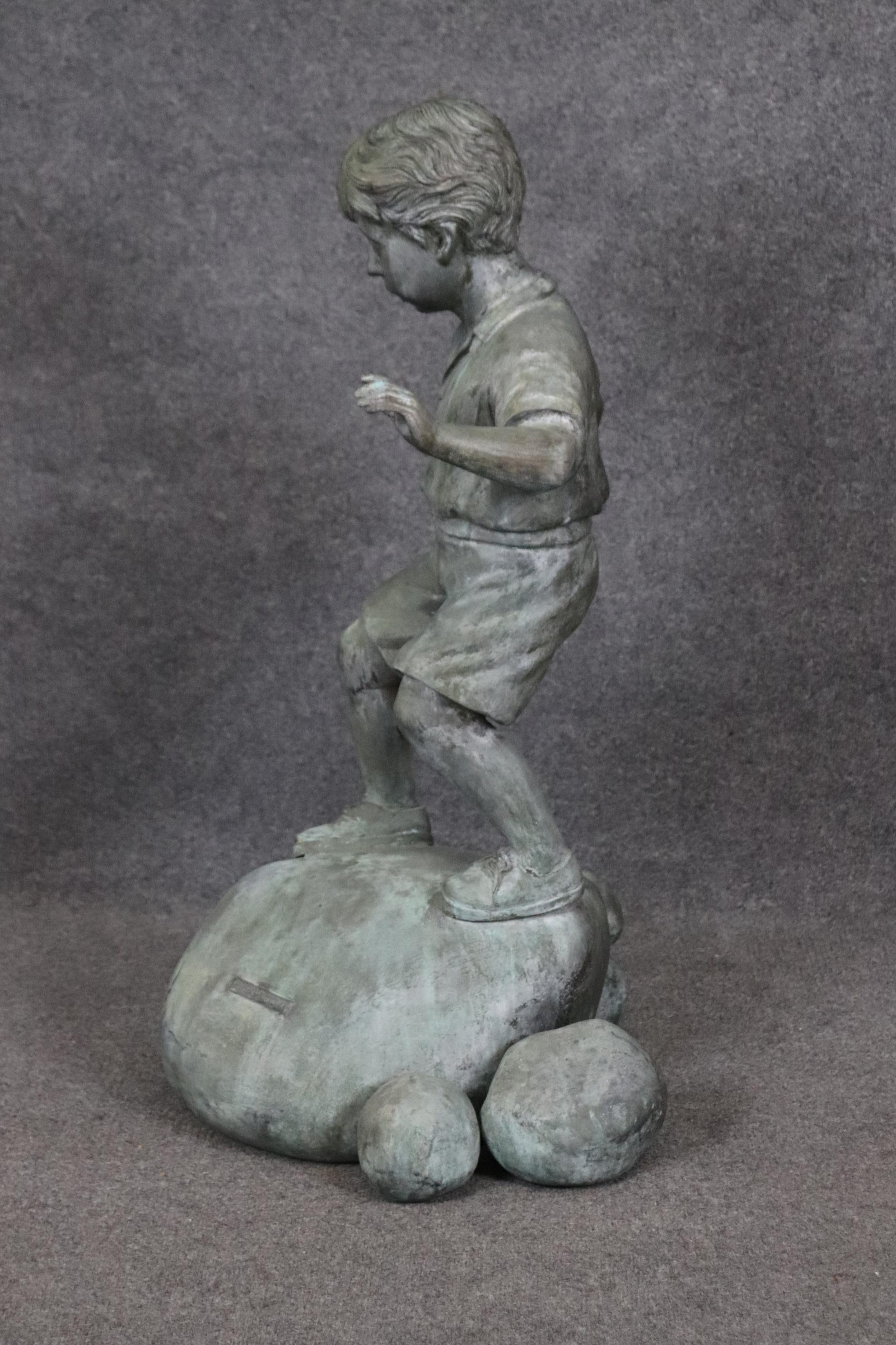 Bronze Elite by Henre in Verdi Gris Outdoor Statue of a Young Boy on a Rock In Good Condition For Sale In Swedesboro, NJ