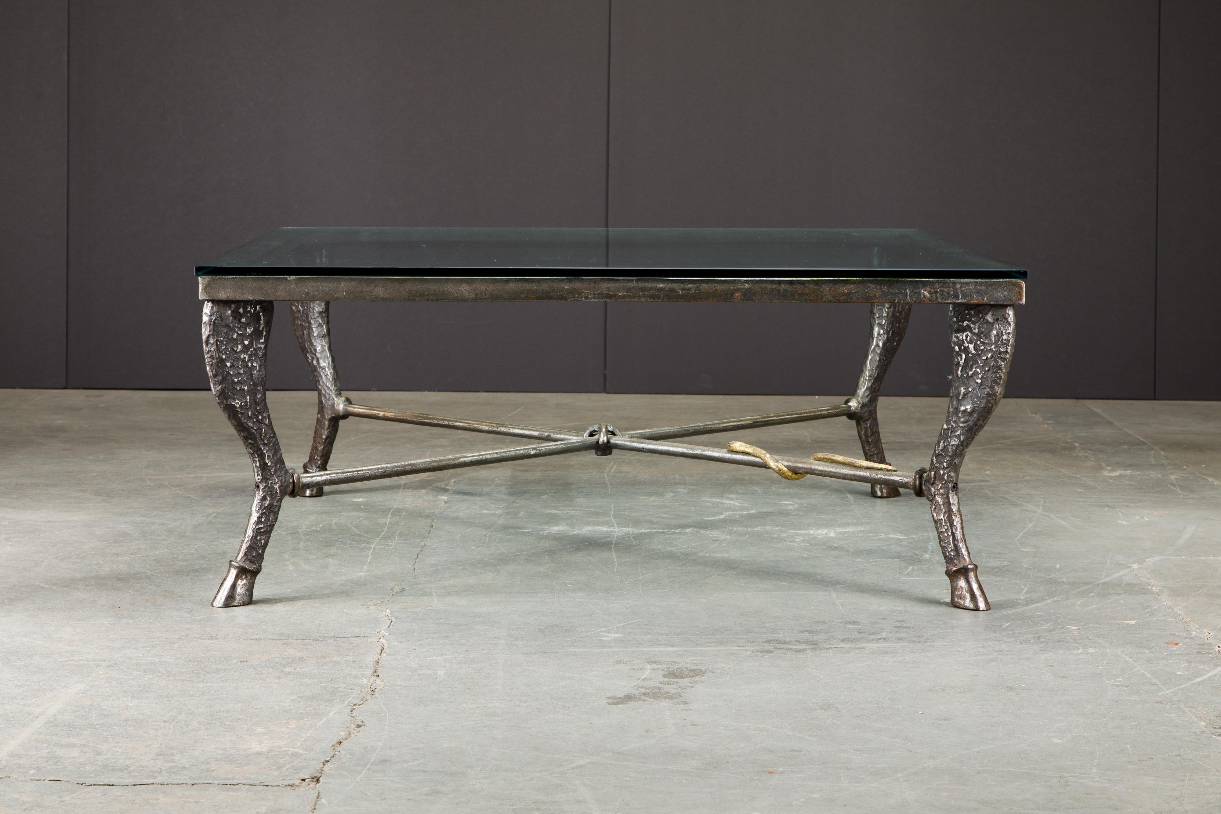 This beautiful patinated and gilt bronze 'Etruscan' coffee table by Christopher Chodoff, circa 1984, features beautiful details including the gilt bronze snake which appears to be crawling on the x-shaped stretcher knotted together in the center