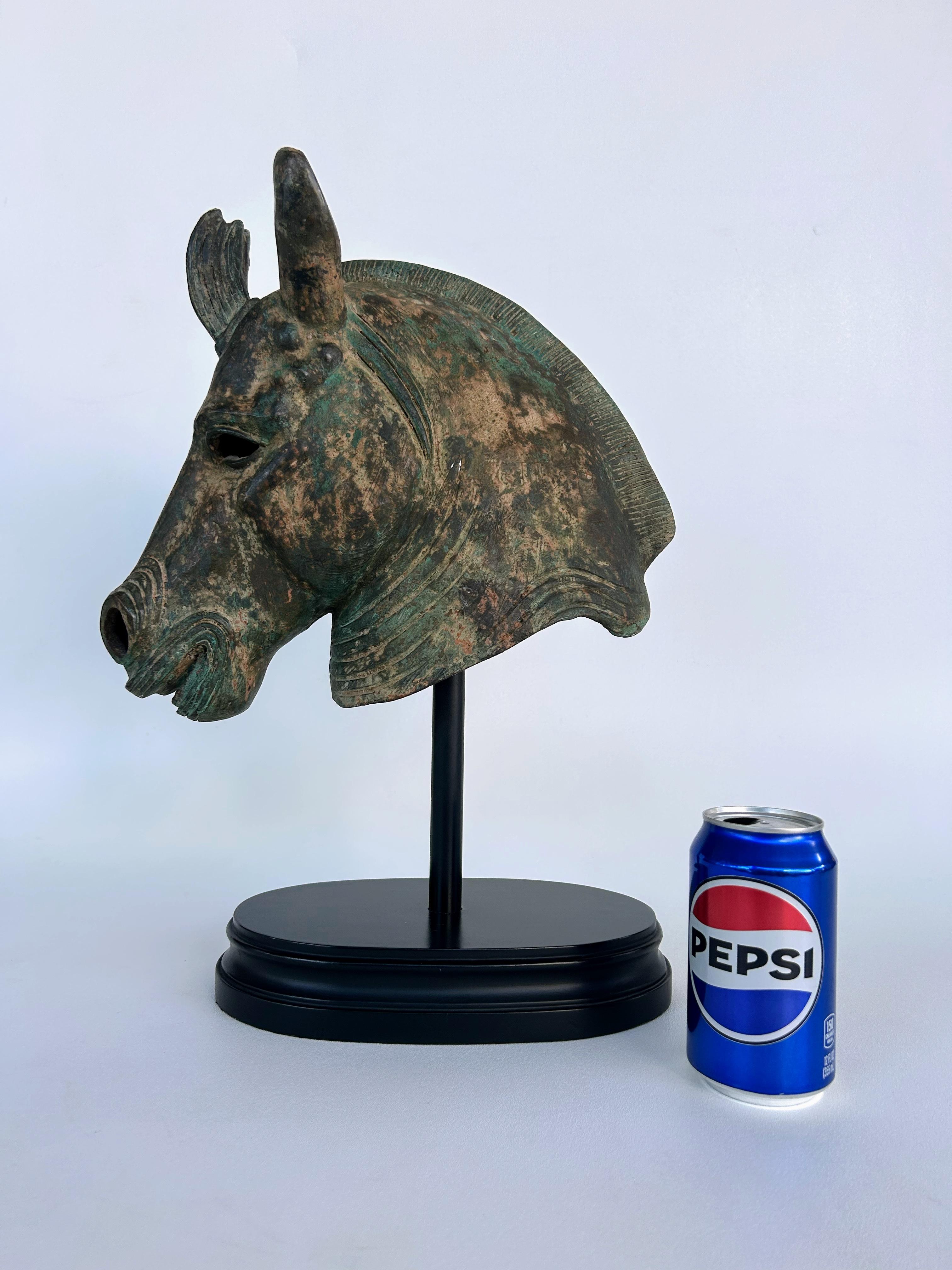  Bronze Etruscan Style Horse Sculpture, Verdigris Finish Raised on an Oval Base

Offered for sale is a decorative bronze Etruscan-style horse head sculpture with a verdigris finish that is raised on an oval wood base. The bronze has an aged patina.  