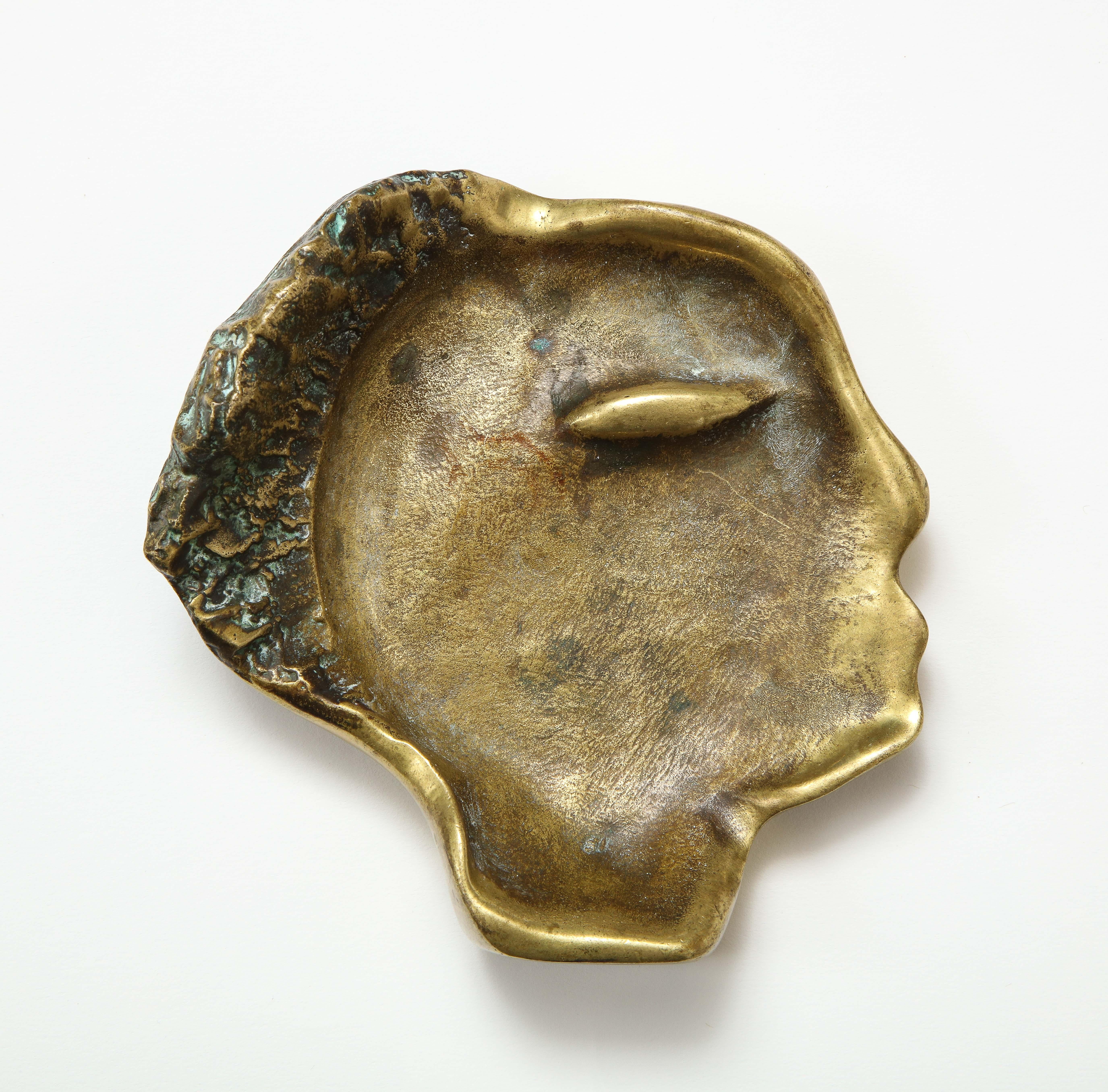 Bronze videpoche in the shape of a face, France, circa 1960.