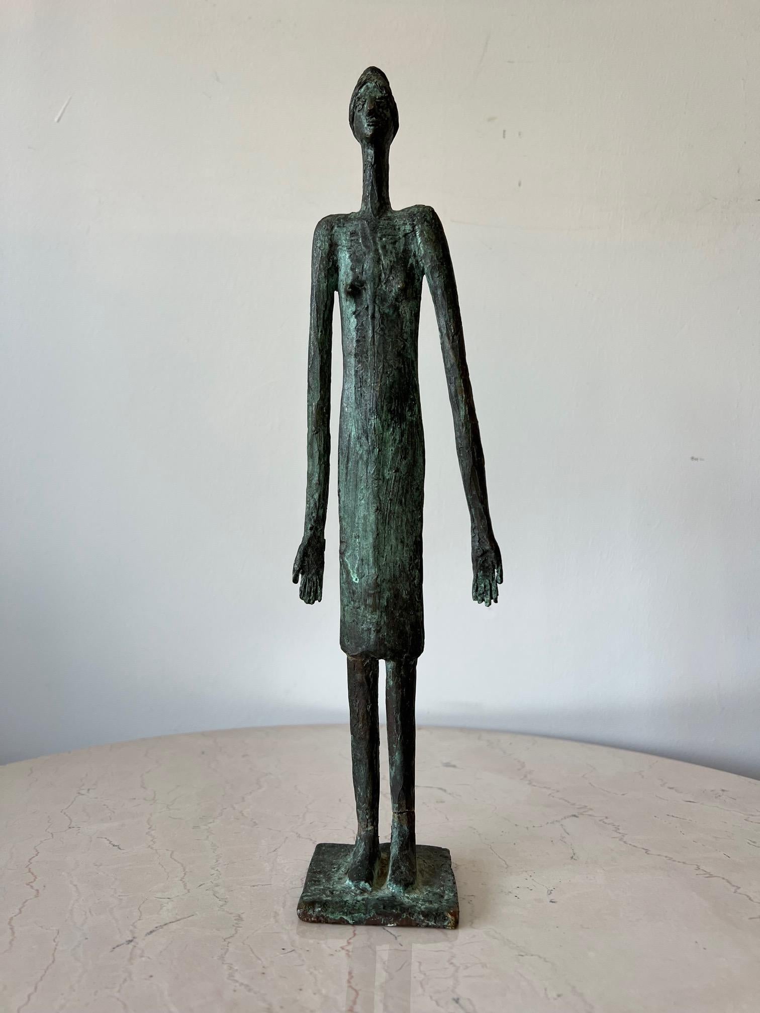 An unusual cast bronze sculpture by Anne Van Kleeck. Elongated figure-exaggerated and inspired by Giacometti. From the artist's estate. A note about the artist: Anne Van Kleeck was primarily known for her works in cast bronze and ceramics. She