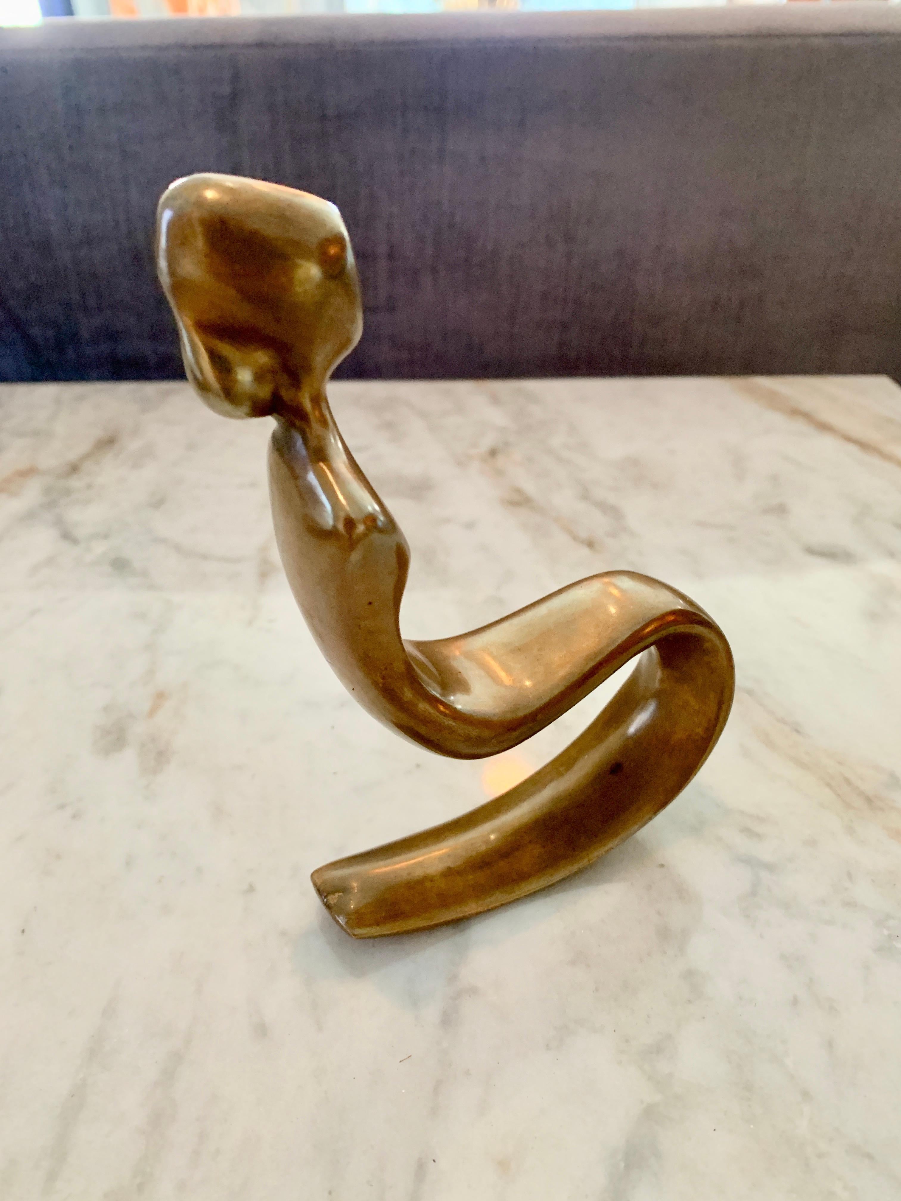 A bronze paperweight of Rocking woman - the paperweight is signed and numbered and make a great stand alone sculpture or paperweight. The piece rocks back and forth without falling over.