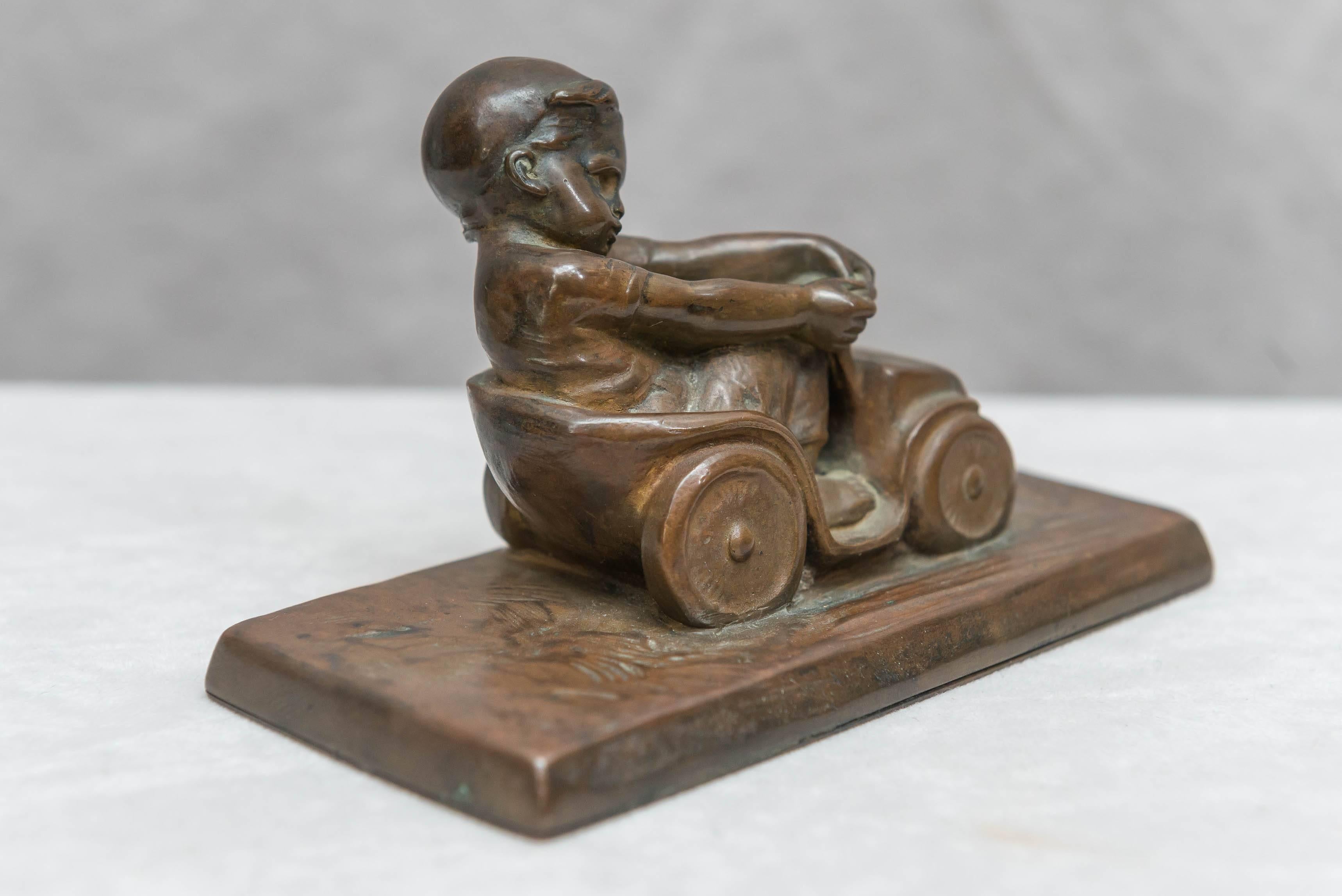 Patinated Bronze Figure of a Little Boy in a Toy Car, Artist Signed Tereszczuk, circa 1910