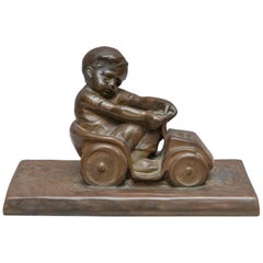 Bronze Figure of a Little Boy in a Toy Car, Artist Signed Tereszczuk, circa 1910