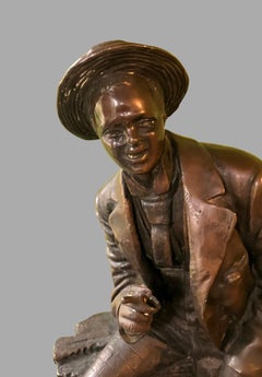 Bronze Figure of a Jauntily Seated Man With a Cane