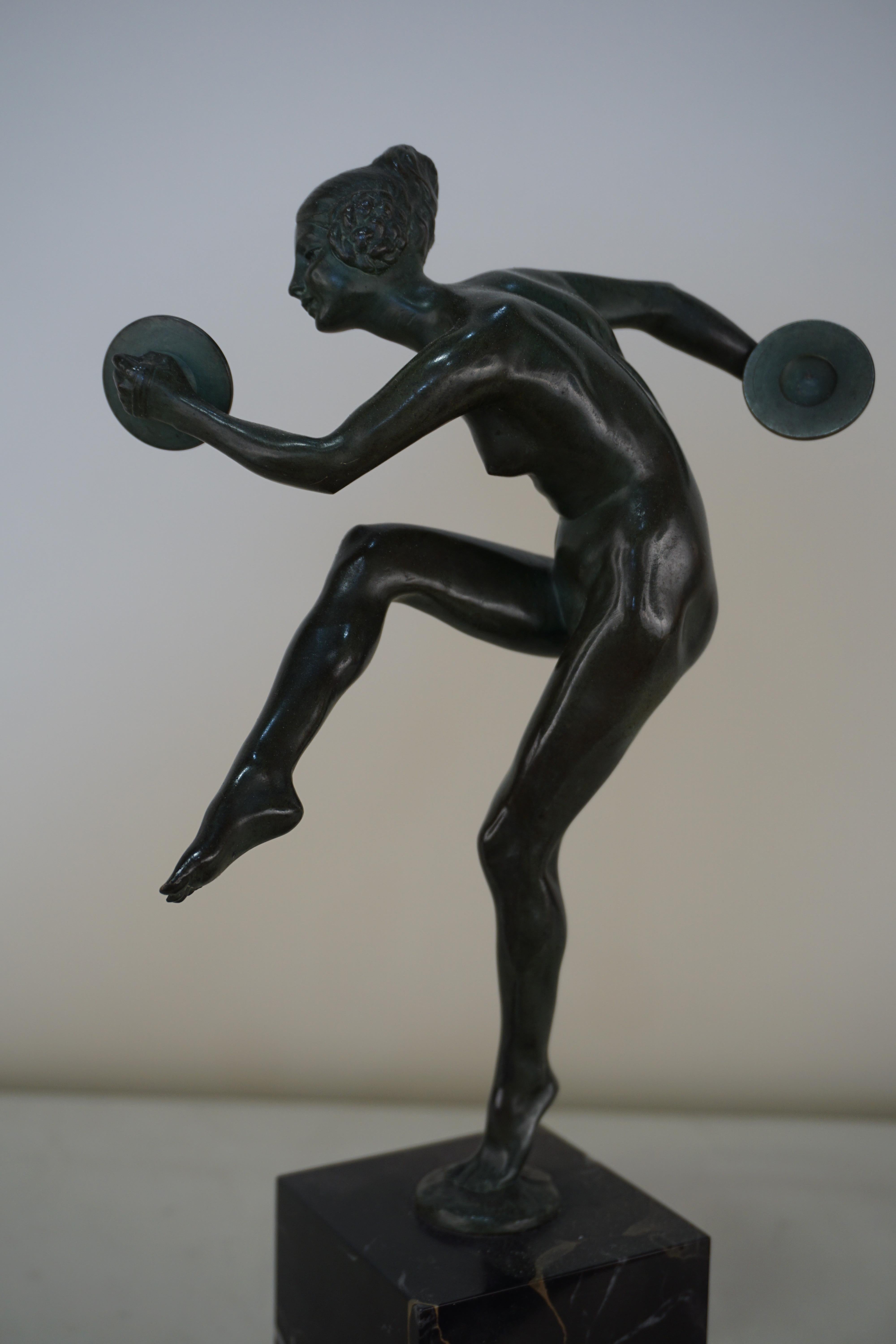 French bronze Art Deco nude with cymbals dancer with balanced on the toes of one foot.
By Lucien Charles Edouard Alliot.
 