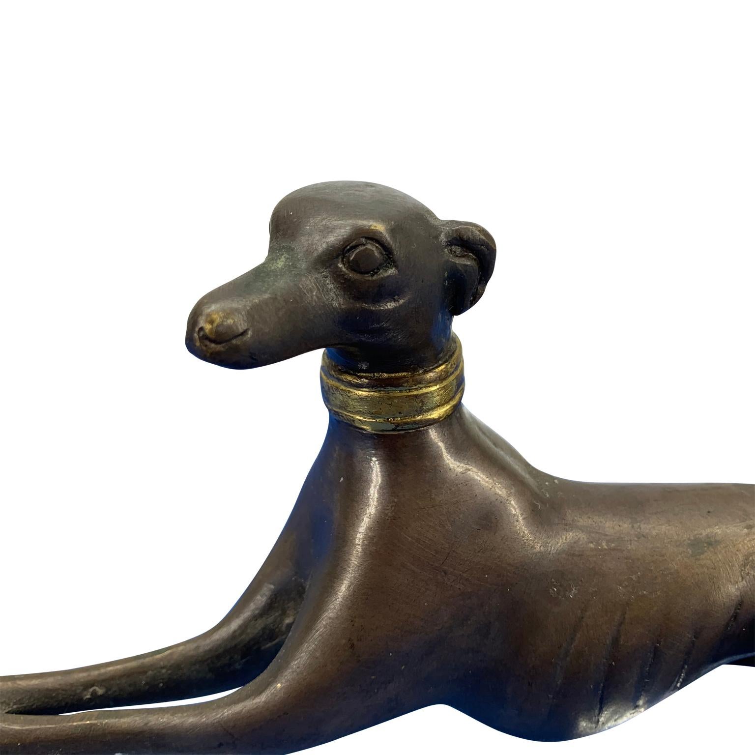 Bronze figure of greyhound with gilded collar

Patinated bronze sculpture of greyhound with polished bronze collar.